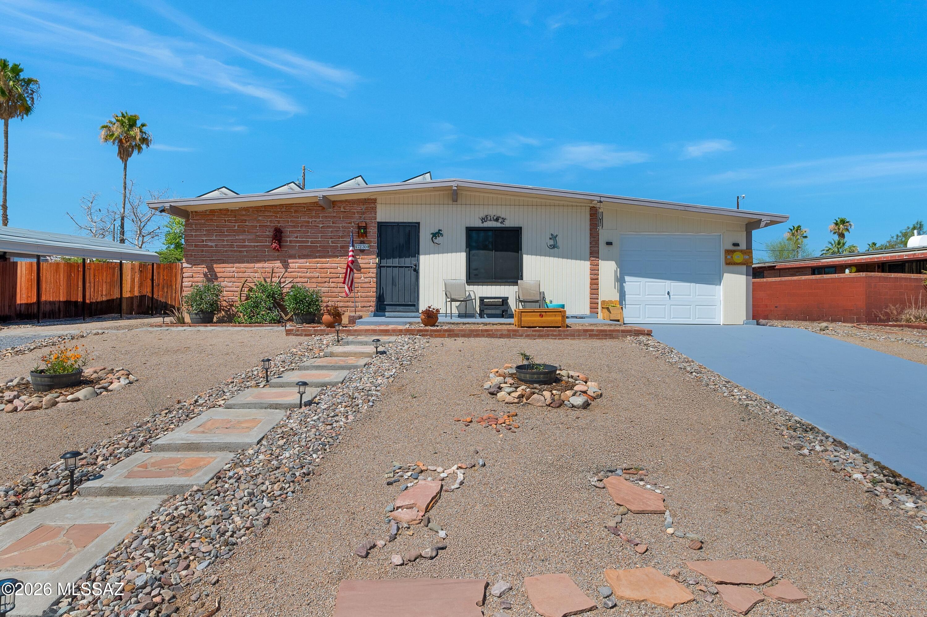 Burnt Adobe Spectacular! Freshly Painted! Updated Flooring, Updated Kitchen & Baths,  Granite counter-tops in Kitchen, updated Stainless Appliances, & Track Lighting! Ceiling Fans in almost every room, and Security Screens on all Windows! Additional Family Room through French Doors leads to walled rear yard with Storage and Workshop!  Back Yard with Firepit & Grill &  Patio Furniture stays. Single Garage + Large Carport to keep Autos COOL in Summer! Central A/C & Gas Heat just 5 years old! Solar installed in 2020 to keep COOL with low monthly bills!  Exterior Adobe sealed in 2019. Assumable VA loan.