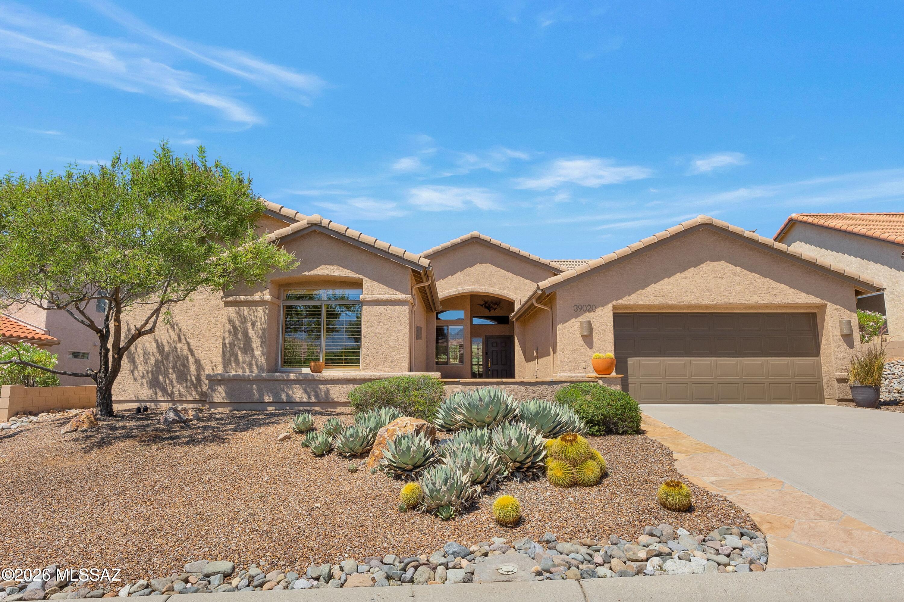 Dakota with Guest House & Nature Behind! Freshly painted exterior 7/2026. Flagstone path leads to the Guest House with serving station, closet, & bath. Welcoming foyer opens to spacious Great Room & Dining Area to entertain. Kitchen offers quartzite counters, black appliances, island, abundant cabinetry & dining nook. Family Room features gas fireplace, electric rolling window shade & slider to patio. Spacious Owner's Suite with EnSuite bath featuring a custom walk-in shower & walk-in closet. Two Guest Bedrooms with closets & nearby Guest Bath. Plantation shutters throughout. Laundry Room with W/D, utility sink & cabinets. Extended 2-car garage with 2021 HVAC's, 2017 W/H & cabinets. Covered flagstone patio extends to additional flagstone patio with nature behind to relax & enjoy!