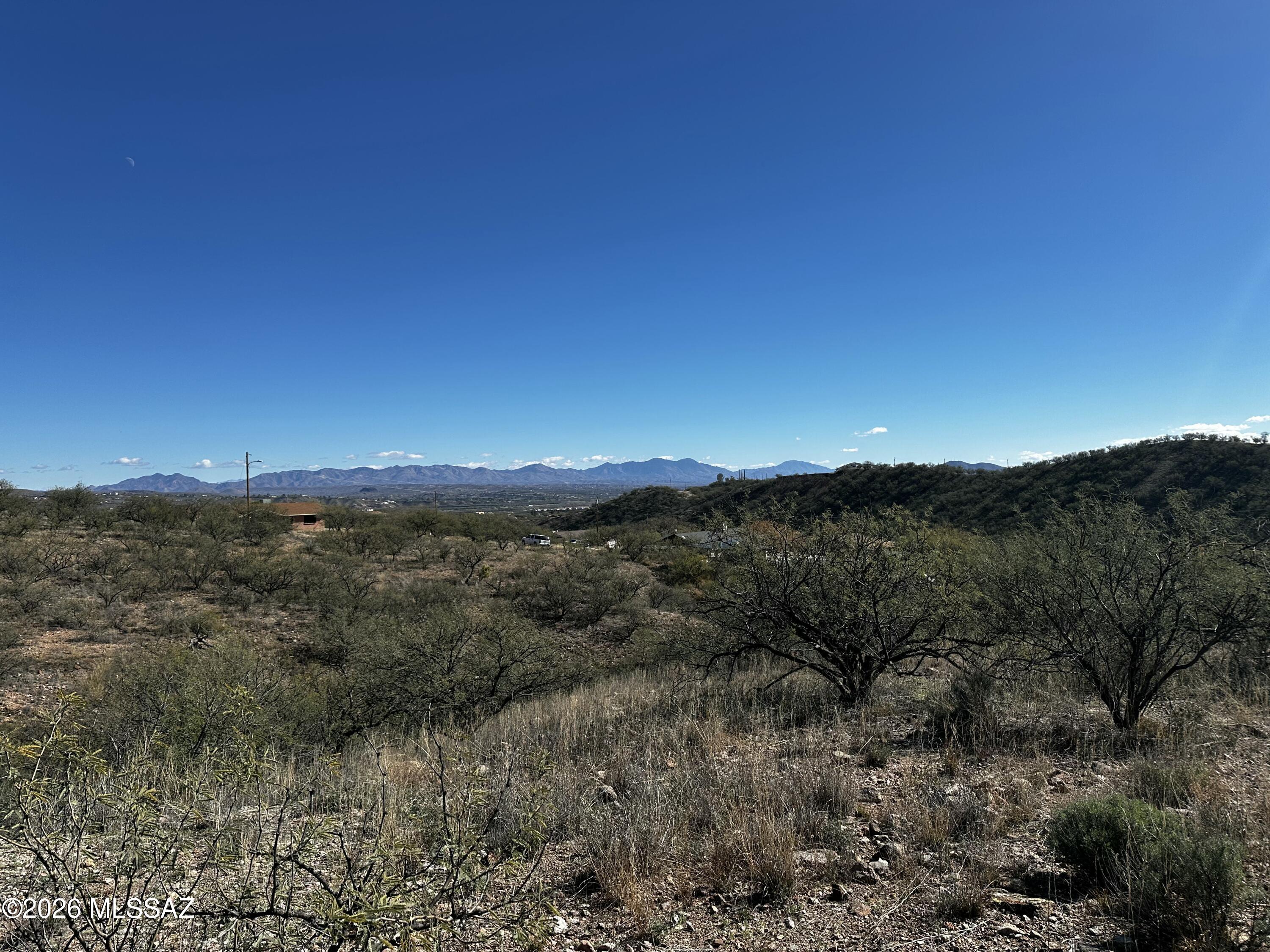 Large lot, over an acre of  land, at the end of the street. Mountain and desert views in a serene part of Rio Rico. Close to the freeway and easy access to stores and schools. All information, including availability of utilities should be verified by buyer during the due diligence period.