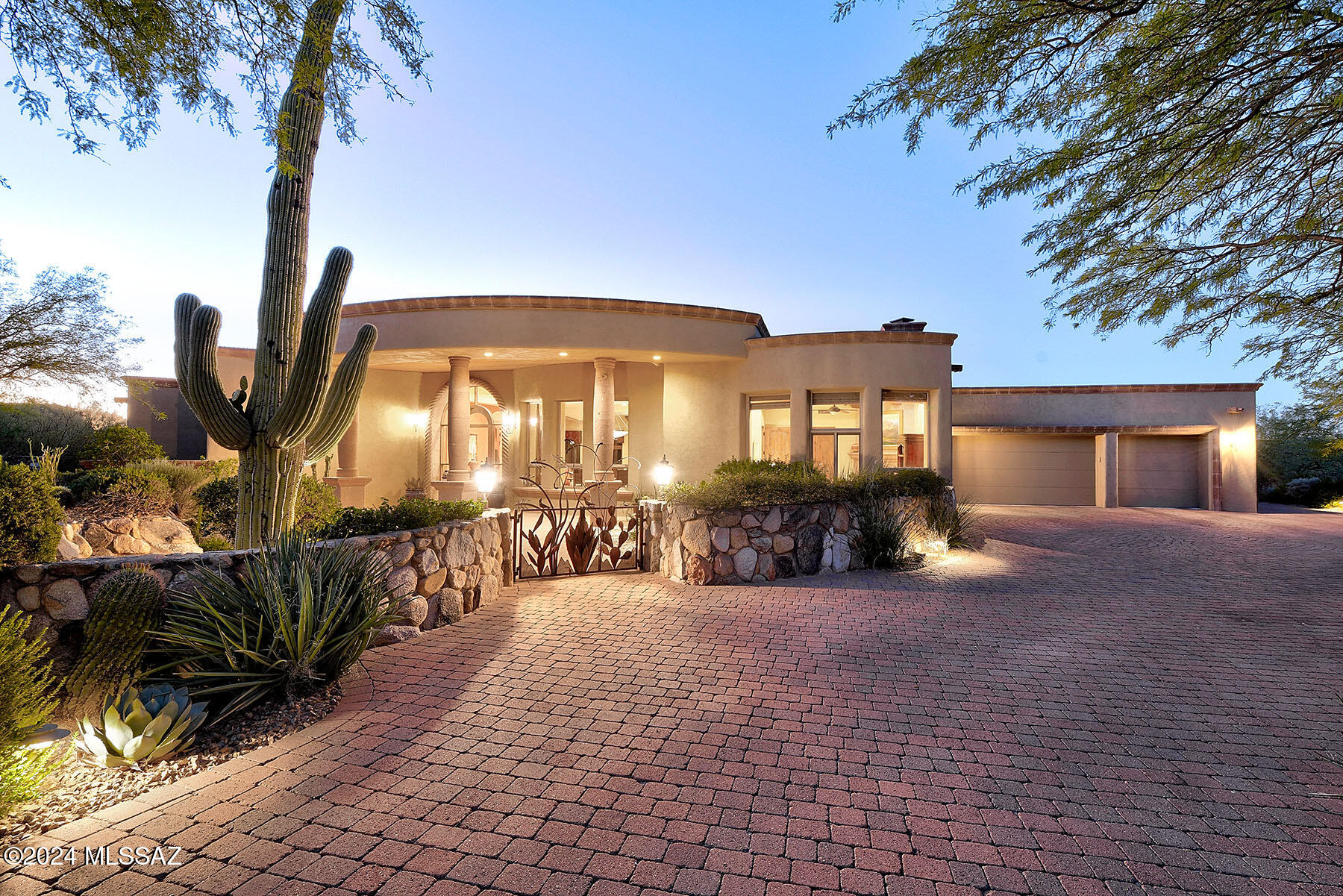 Outstanding and meticulously cared for all-masonry stucco Southwestern/territorial-style home with 4 bedrooms (den with closet could be 4th bedroom), 3 baths, 4,389 sq. ft., in prestigious, guard-gated Pima Canyon Estates.  Located on a cul-de-sac on a .91 acre city and mountain view lot. Follow concrete paver driveway to professionally landscaped front yard, native stone walls and accents, courtyard entry and arched, hand-painted front door into foyer with coved ceiling.  Charming great room has travertine tile floors, Cantera stone pillars and banisters, soaring beamed ceiling with corbels, Cantera stone fireplace with accents and ideal seating for mountain, backyard and city views. Dining room with coved ceiling and mountain & city views.  Kitchen offers expansive center island with granite counters, 6-burner professional gas cooktop, stainless steel appliances, knotty alder cabinetry and doors (throughout home) and breakfast area.  Gracious primary suite has high beamed ceiling with corbels, beehive fireplace with cantera stone accents, generous walk-in closet with built-ins, dual vanities, a separate shower and jetted tub. 14' X 17' den/4th bedroom has closet, corner Cantera fireplace, beamed ceiling with corbels, and mountain views.  Professionally landscaped backyard features expansive porch, flagstone patios and walkways, built-in BBQ, pool/spa with Cantera stone accents, native stone walls, and a fireplace with banco seating.  Additional features include a 3-car garage, updated mechanical and HVAC systems, surround sound in all rooms and outdoor spaces - including equipment, and so much more.  See to appreciate.