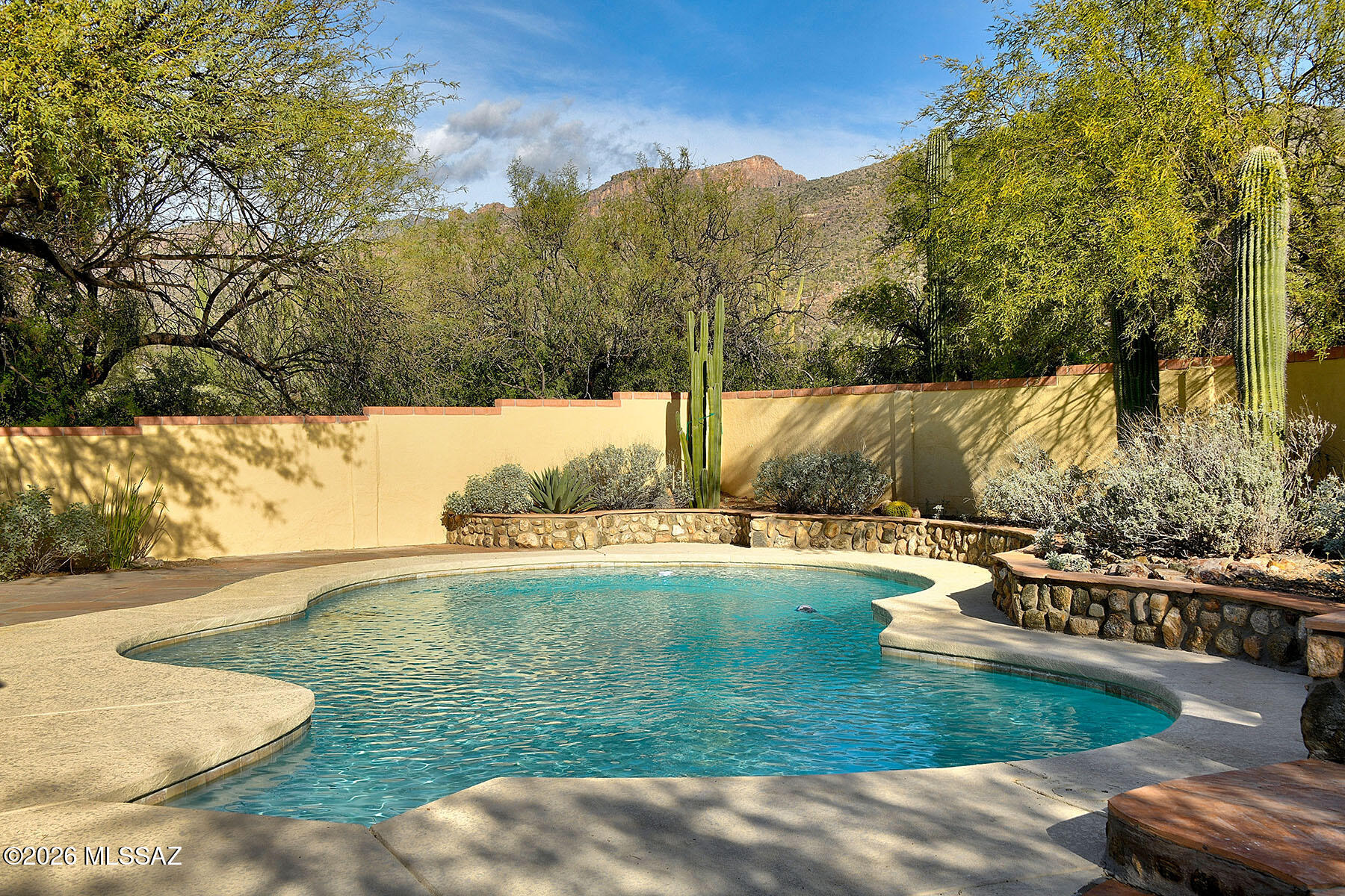 Set on 3.51 acres of horse property, with incredible mountain views, this home is both beautiful and functional.
Inside, you will find two dedicated home offices, one office can function as a sleeping area for guests, knotty alder interior doors, hardwood floors, and 
travertine tile throughout the main living areas.
The kitchen is designed for serious cooking and everyday gatherings. It features knotty alder cabinets, a large center island, stainless steel appliances, a six-burner gas range with griddle, and a pot filler faucet. The layout opens to the dining room and fireplace, making it ideal for entertaining.
The primary suite is generously sized and feels like a private retreat. The bathroom includes a jetted tub, walk-in shower, and dual vanities with electric anti-fog mirrors. Outdoor living is just as impressive. A salt water pool and outdoor fireplace create a great space to relax or host guests.
The property is well set up for horses, with a turnout area, barn with pipe pens, and room to park trailers or RVs on site.
Additional features include a two-car garage with a separate workroom and full bathroom, plus leased solar to help with energy efficiency.
This is a well-rounded property that blends thoughtful interior finishes with true functionality for rural living.