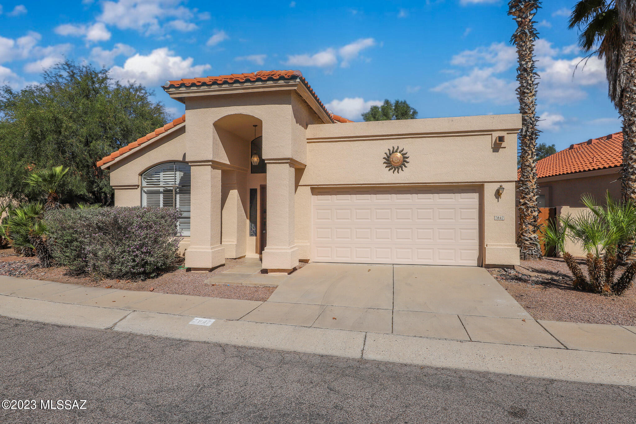 Don't miss this beautiful home in The Enclave, a small sought after subdivision in NE Tucson that backs to the Tanque Verde wash. Features include high ceilings, wood flooring in main areas, plantation shutters, and custom bookcases.  Kitchen offers newer S.S. appliances, S.S. farm house sink, spacious island perfect for entertaining & pantry. The primary bath offers double door entry, private exit to rear yard, double sink vanity and spa tub with custom tile surround. The private patio & rear yard is the perfect place to relax or enjoy the mountain views from the riverwalk with flowing water during our rainy season or spring snow melt. You will see neighbors sitting in beach chairs while their children play in the water. Something we desert rats long for.