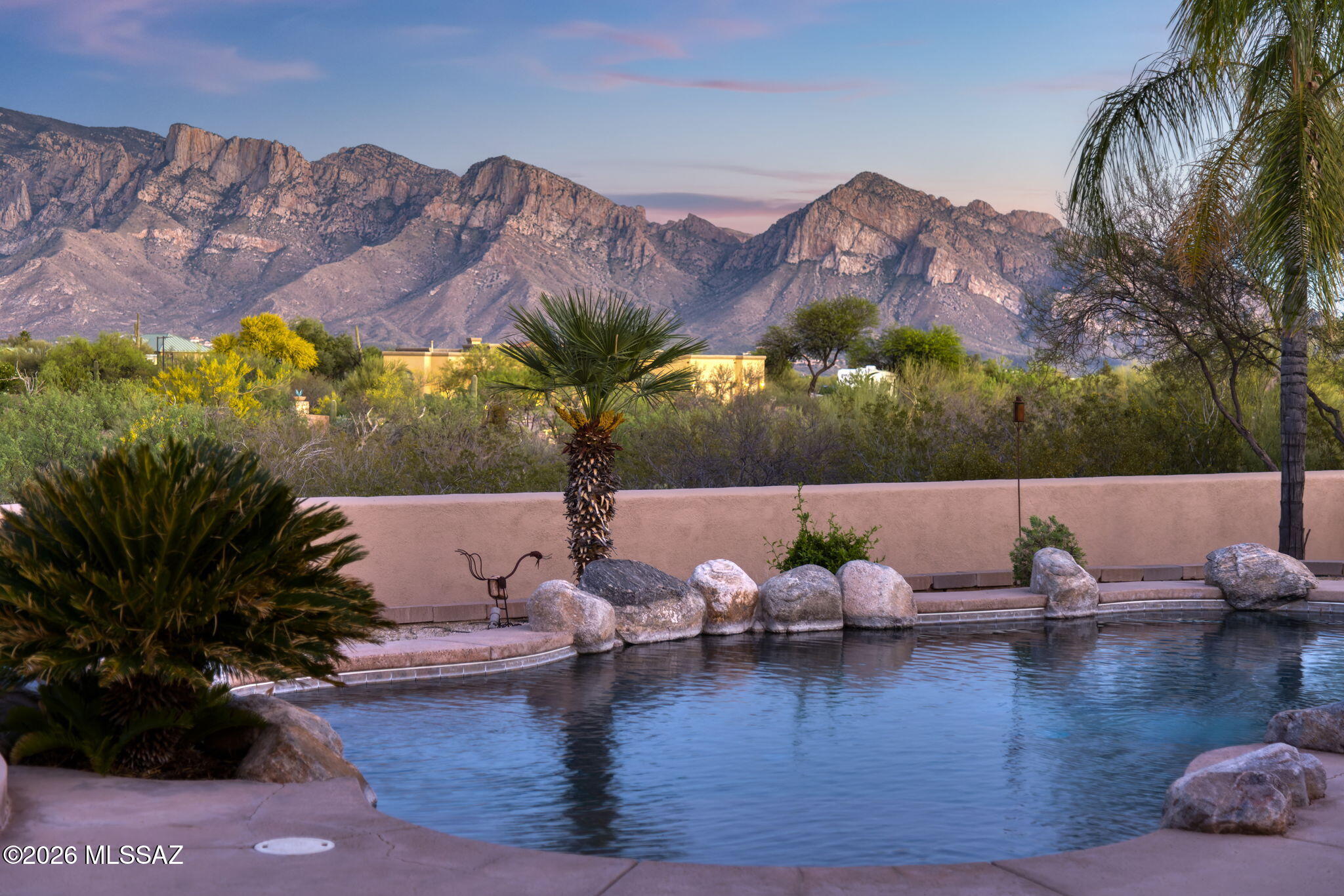 Welcome to 1701 W. Moore Rd--an exceptional desert retreat set on 3.3 acres with unobstructed Catalina Mountain views. Tucked away with generous space from neighbors, this property offers a peaceful setting while still being conveniently located in the sought-after Northwest Tucson/Oro Valley corridor.

 Designed for both comfort and entertaining, the backyard is a true resort-style oasis featuring a sparkling pool and spa, built-in BBQ, and an expansive covered patio--perfect for hosting gatherings or simply enjoying Arizona's stunning sunrises.

 Inside, the home offers a spacious yet functional split floor plan. The kitchen is thoughtfully designed with abundant workspace, a prep sink, two walk-in pantries, and a dry bar--ideal for everyday living and effortless entertaining. A larg laundry room adds convenience with a built-in desk, ample storage, and a utility sink.

The primary suite is an enormous private retreat showcasing breathtaking mountain views, a cozy fireplace, a large walk-in closet, and its own secluded patio. On the opposite side of the home, two guest bedrooms share a Jack-and-Jill bathroom, while a third guest room features exterior access and a quiet patio--perfect for a private office.

An attached 1 bed, 1 bath casita with its own living room and kitchenette provides excellent flexibility for guests, multigenerational living, or rental potential.

Car enthusiasts and hobbyists will appreciate the oversized 3-car garage with built-in storage, plus an additional storage room.

The property is serviced by a shared well among six parcels on the street and includes a private road agreement.

 A rare opportunity to own a spacious, well-appointed home with incredible views, privacy, and amenities--this is desert living at its finest.