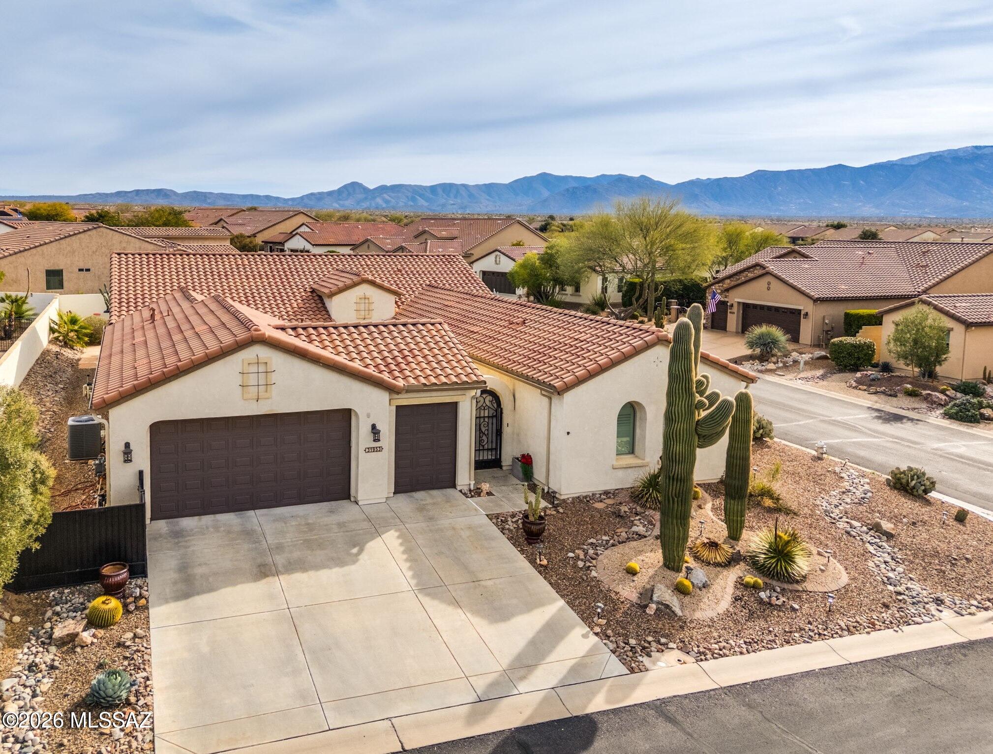 Spectacular Mirasol model welcomes you with an inviting gated courtyard and resort style yard with heated pool/spa and linear fire pit. This elegant 3BD/3.5BA (2,635 sq ft) home on large, corner lot affords a spacious feel and offers an attached Casita with private courtyard entrance. Step into this home with circular foyer and experience soaring ceilings, gorgeous plank flooring throughout with carpeted Casita, large open Den with bookshelves plus a cozy Library alcove for reading enjoyment. Open concept Gathering room is highlighted by walls of windows overlooking the stunning backyard. Sleek chef's kitchen hosts a large center island with bar seating, granite countertops and GE Profile stainless appliances including in-wall ovens and electric cooktop. Split bedroom plan allows for added privacy boasting a luxurious Owner's Suite with large bay window, luxury spa bath and custom walk-in closet. Guest room and Casita feature en suite baths with lovely wood shutters in Casita. Additional powder and laundry rooms. Extended 2.5 car golf cart garage features an oversized garage door for larger vehicles, ample storage cabinets plus utility sink. Reimagined rear yard boasts a large, covered patio, outer Travertine decking and pool surround, outer flagstone patio plus linear gas fire pit, large heated pool & spa with waterfall, plus raised outer wall for privacy. SaddleBrooke Ranch Active Adult Community offers resort style amenities, panoramic mountain vistas and a tranquil setting in the high desert.