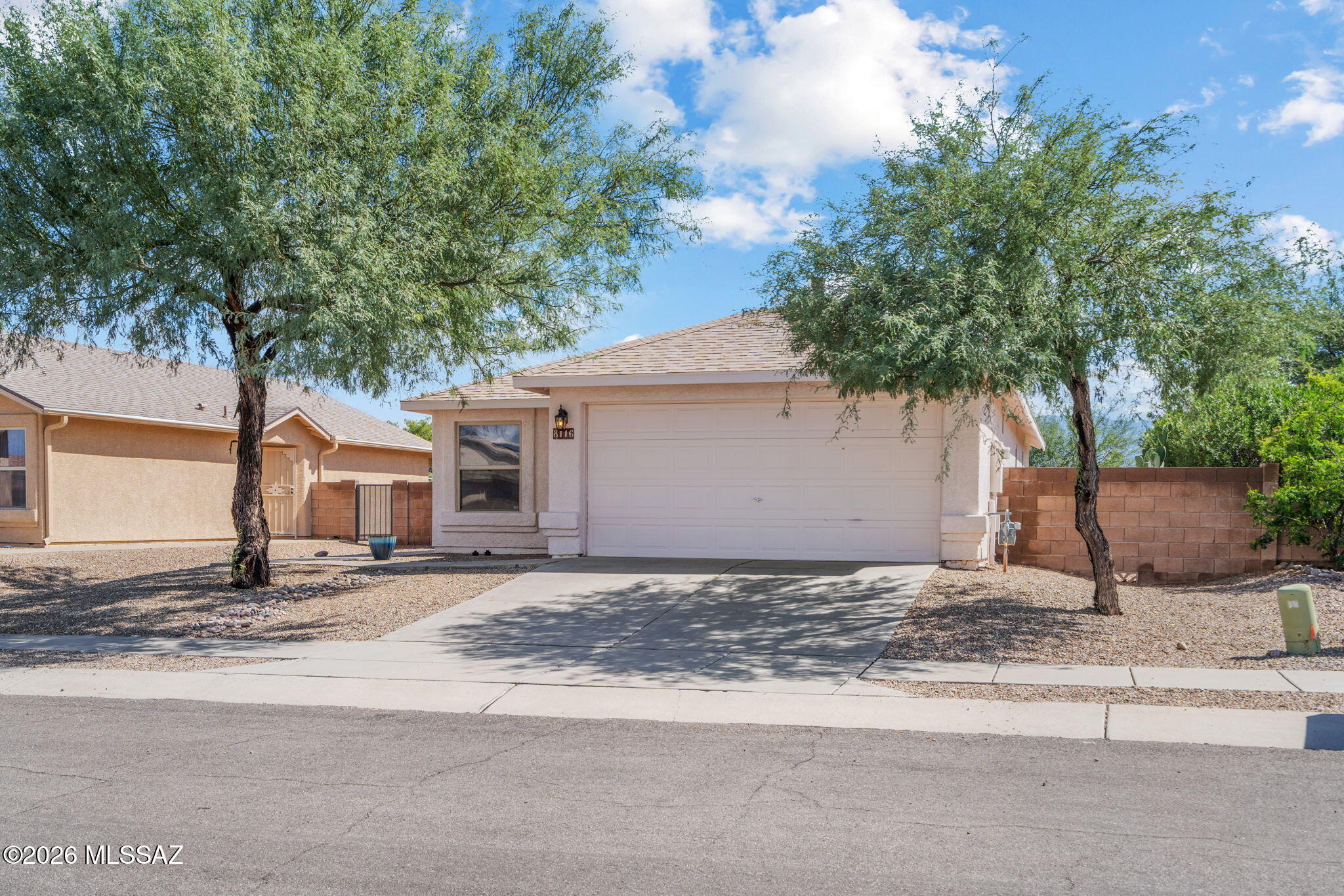 Discover easy living in this inviting 2-bedroom, 2-bathroom home featuring a versatile den that can serve as a 3rd bedroom. The open floorplan seamlessly connects the kitchen to the great room, highlighted by a vaulted ceiling and abundant natural light. Recent updates provide added peace of mind, including a stainless refrigerator replaced 2025, gas range and microwave replaced in 2019. Roof replaced in 2021 with recent maintenance in 2026. The HVAC system and water heater were replaced in 2021. Exterior paint and stucco in 2021, and a new water main was installed in 2020. Step outside to a nicely sized, fully walled yard with fruit trees and an irrigation system. Armoire with drawers, refrigerator, washer and dryer all convey. Convenient location-schools, shopping, and Davis-Monthan AFB
