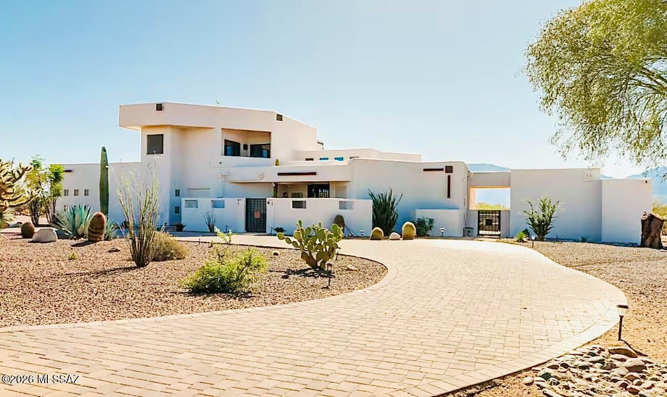 Private, 7 acres, Gated La Cholla Airpark Stunner with Direct Access to a lighted runway, 360° Mountain Views, Pool & Spa, Outdoor Kitchen Ramada with Fireplace. Whole House Automation, Chef's Kitchen, Downstairs Guest Suite w/Wet Bar, Primary Suite on 1st floor will not disappoint! with fireplace and patio access, Exercise Room, second story Bedroom and Office w/Wet Bar, Loft & Decks; Owned 90 panel Solar System, Climate Controlled Garage or Hangar, Zoned For Horses.