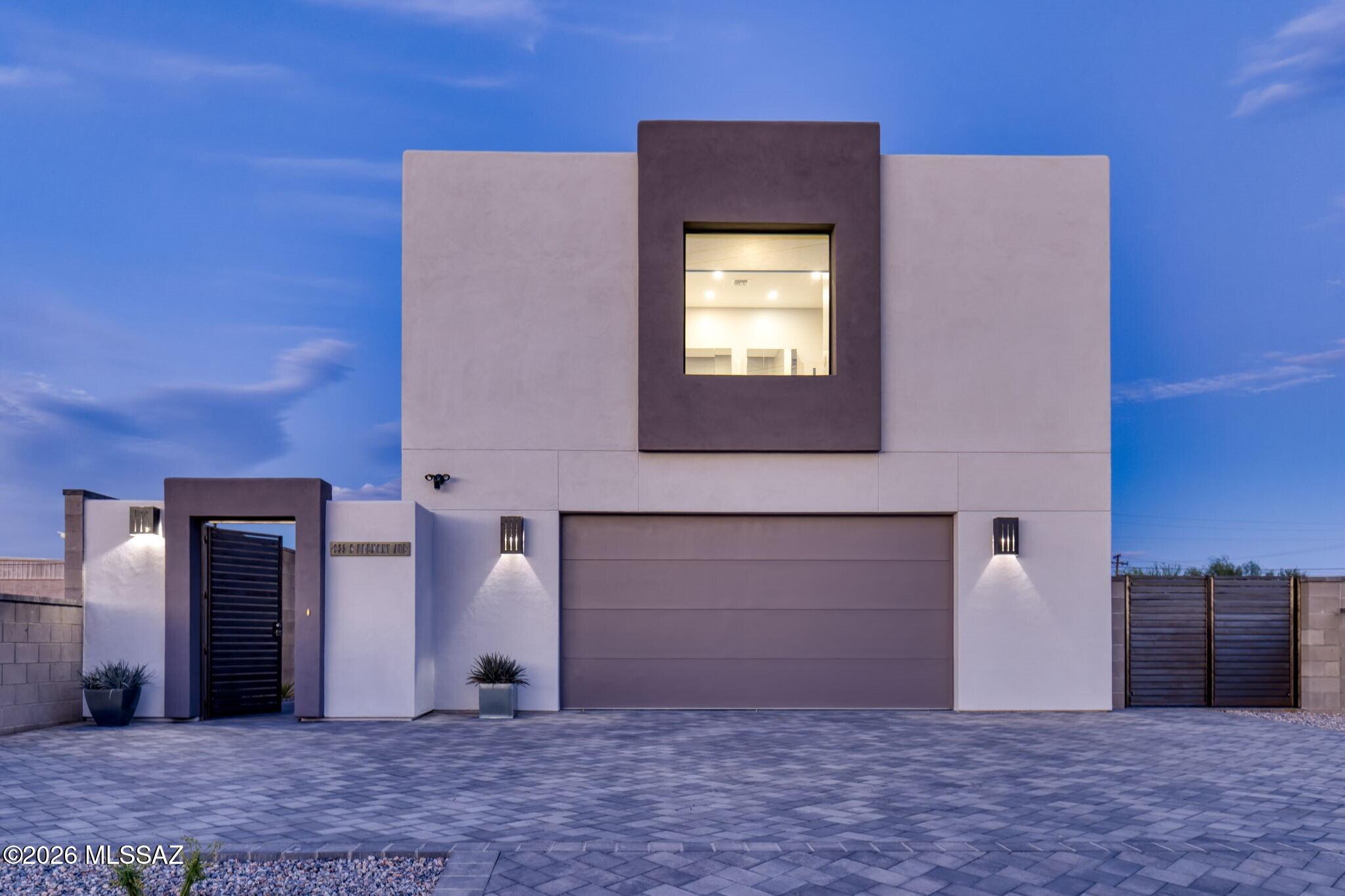New construction in historic Millville offers a distinctive take on downtown Tucson living. At 935 S Fremont, contemporary architecture, a detached casita, two-car garage, private outdoor spaces, and views of A Mountain and the Downtown Tucson skyline come together in one of the city's oldest barrios. No HOA!

Millville is an evolving pocket of downtown where historic homes, industrial and commercial spaces, and newer residential construction share the neighborhood. It's a mix of old and new that feels distinctly Tucson, with independent businesses and creative spaces adding to its character. Local favorites like Slow Body Beer and Holy Focaccia are nearby, along with the restaurants and cafés of 5 Points, the Mercado District, galleries, shops, and live music downtown. The University of Arizona is just minutes away. Fremont's tall privacy walls and outdoor patios create a private setting for dining, entertaining, and enjoying Tucson's weather, with the restaurants, art, music, and energy of downtown just minutes away.

The first completed residence in a collection of four homes, Fremont was built by a team with nearly 30 years of experience in custom home construction. That experience is reflected in the materials and architectural details, from the open Douglas fir staircase and custom steel railings to the expansive windows and custom steel patio doors. The outdoor spaces offer room for dining, entertaining, or simply enjoying Tucson's weather, while the two-car garage and paver driveway provide additional off-street parking.

Inside, soaring ceilings and expansive windows bring natural light into the living spaces. The kitchen features floor-to-ceiling cabinetry, an oversized island, and carefully selected finishes, opening directly to the living and dining areas. Spray foam insulation and electric shades are among the details incorporated into the home's design.

Upstairs, the primary suite takes advantage of views of A Mountain and the Downtown Tucson skyline. A freestanding soaking tub sits beneath a picture window overlooking the city, while a full-height tiled walk-in shower, dual vanities, and a walk-in closet complete the suite.

The detached casita has its own living area, kitchen, bedroom, and full bathroom, with possibilities that go well beyond a traditional guest house. Think extended family, a college student attending the University of Arizona, or friends visiting for the weekend. An artist could have a dedicated studio, a business owner could work separately from the main house, or the space could potentially generate rental income. Having a second living space opens up plenty of options for the next owner.

Fremont brings together the architecture and comfort of new construction with the history, creativity, and independent culture of downtown Tucson.