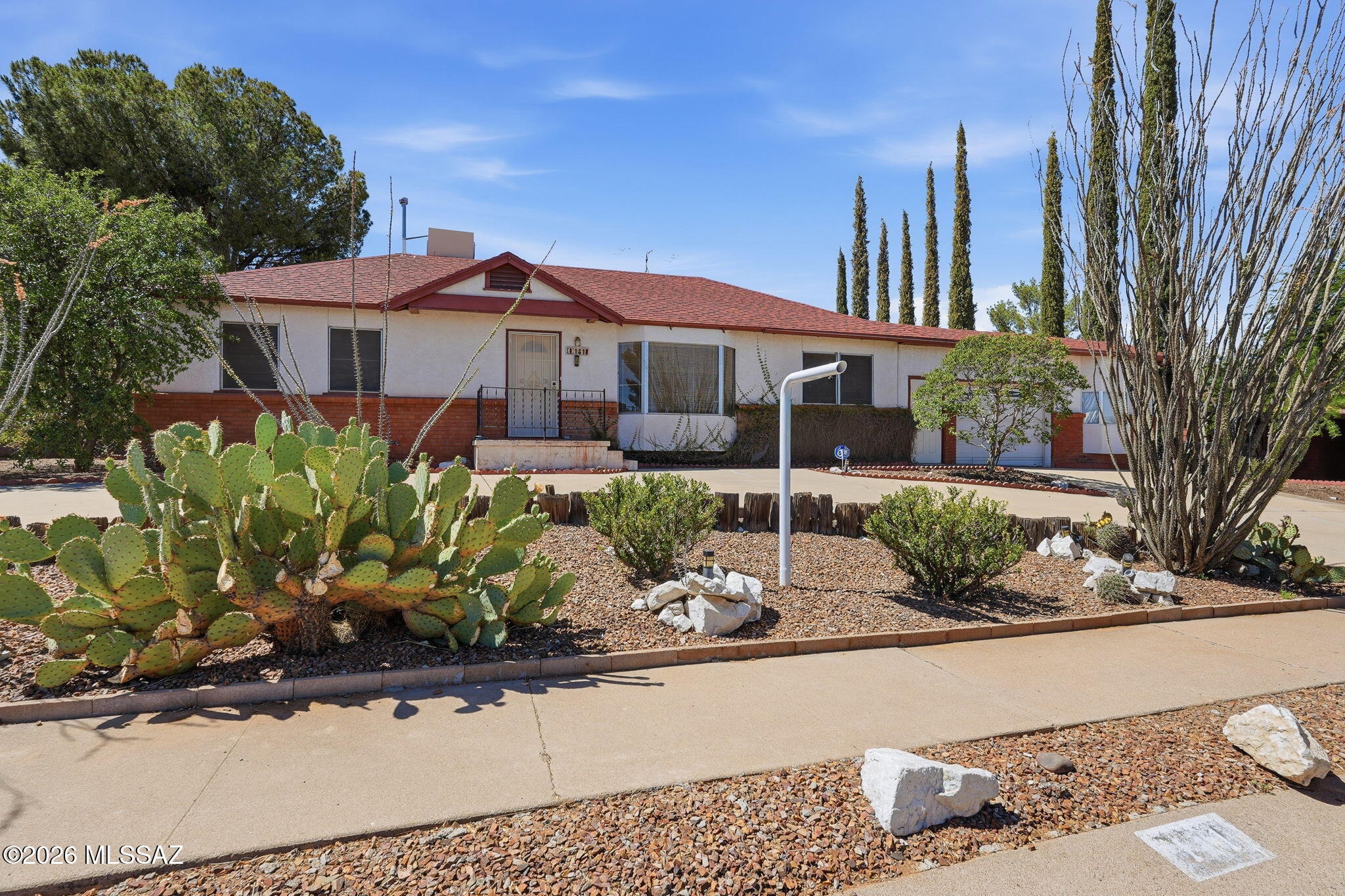 Some homes are just built for real life. This home features an Arizona room for morning coffee, the workshop for weekend projects, the backyard big enough to actually use, and the kind of vintage character that new construction doesn't offer.  3-bedroom, 2-full-bath, 1,254 square feet of thoughtfully used space and more storage than most homes twice the size. The kitchen features double-level wood-finish cabinets, a gas stove, and a washer/dryer setup with more storage above. Everything you need, nothing wasted. One bathroom has a bathtub, the other a walk-in shower. The living room's large bay window pulls in natural light, making the space feel big.  Step through to the Arizona room, lots of windows, warm light, that indoor-outdoor Tucson feeling. The backyard delivers: it includes a large paved private patio, two storage sheds, and a fenced yard for pets & privacy.  Also, a dedicated workshop that serious hobbyists and handy buyers will not want to leave. Vintage door handles throughout give the home a personality that newer builds simply can't replicate. For investors, this property has rental history and checks every box a tenant wants.