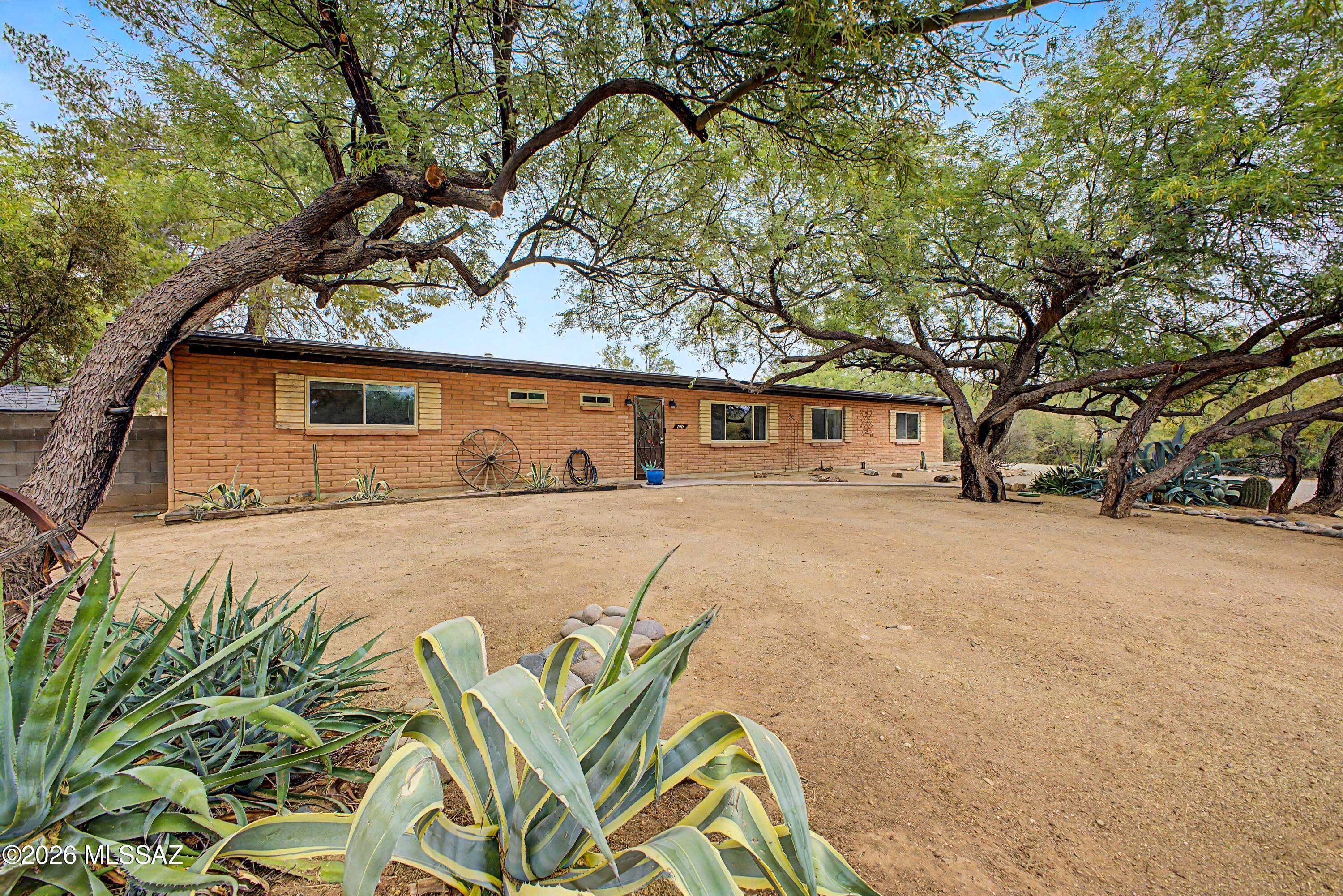 Exceptional horse property on a sprawling 1.268-acre lot with room to live, work, and play! Surrounded by natural desert landscaping, this stunning property is perfectly suited for equestrian use, hobbyists, or anyone needing extra space. From the moment you arrive, the home's inviting curb appeal and natural surroundings make you feel right at home.

This impressive property includes a 1,713 sq ft main residence featuring 3 bedrooms, 2 bathrooms, and a 2-car side-entry garage with extra parking available. New front door and garage entry doors installed (2025). 

The property also includes a 728 sq ft guest house, built in 2020, complete with a fully equipped kitchen, open living area, wood burning fireplace, and a private bedroom with ensuite bathroom-perfect for entertaining guests, extended family, or rental potential.

A standout feature is the impressive 1,200 sq ft steel workshop (2020), which includes an additional 3-car garage, or room for a RV, making it ideal for vehicles, equipment, trailers, or projects.

Inside, the main home features tile flooring and a neutral color palette throughout. The welcoming living and dining area is ideal for gatherings, while the separate family room with a cozy wood-burning fireplace offers the perfect place to unwind.
The kitchen is both stylish and functional, complete with wood cabinetry, stainless steel appliances, granite countertops, and a breakfast bar island for casual dining. 

The spacious primary suite comes with a private ensuite bathroom featuring a large tile shower for added comfort. The remaining two bedrooms are able size and share the hallway bathroom (remodeled in 2023). 

Outdoors, the property truly shines with horse-friendly space, a detached RV garage, workshop, chicken coop, shade trees, covered patio, raised garden beds, and plenty of room for arenas, stalls, or additional customization to fit your needs. Hose spigots are conveniently located throughout the property, providing easy access for irrigation, landscaping, and a variety of outdoor uses.

This versatile property offers the ideal blend of rustic charm and modern elegance-don't miss this unique opportunity to own this home! 

Ask for the seller's upgrades list! Two water harvesting tanks convey with the sale of the home.