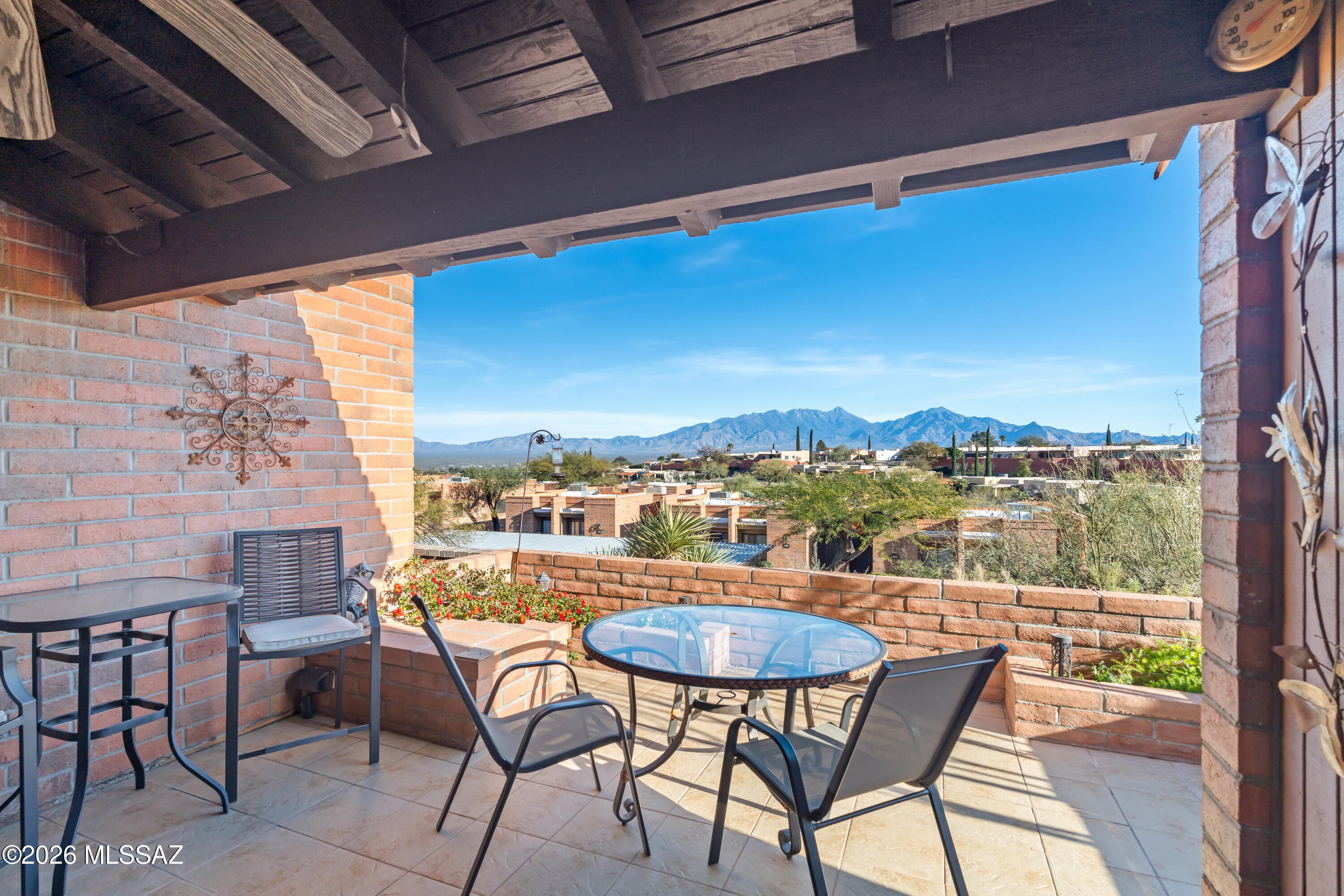 Outstanding straight-on panoramic mountain views from SSE walled rear patio. Enjoy morning sunrises or afternoon sunsets with your favorite beverage watching ever changing shadows of the Santa Rita Mountains and Madera Canyon. Turnkey furnished - perfect destination to enjoy Arizona sunshine or a traveling homebase. Updated interior including kitchen and bath. End unit provides an extra side window to bring in additional light. Covered reserved parking. Green Valley Rec offers the amenities you want or play a round of golf at nearby courses. CCRs currently allow short term rentals - one tenant must be 55+ Winter rent has been $2700/mo. New roof to be installed by Golden Roofing 4/1/2026 with 10 year warranty.