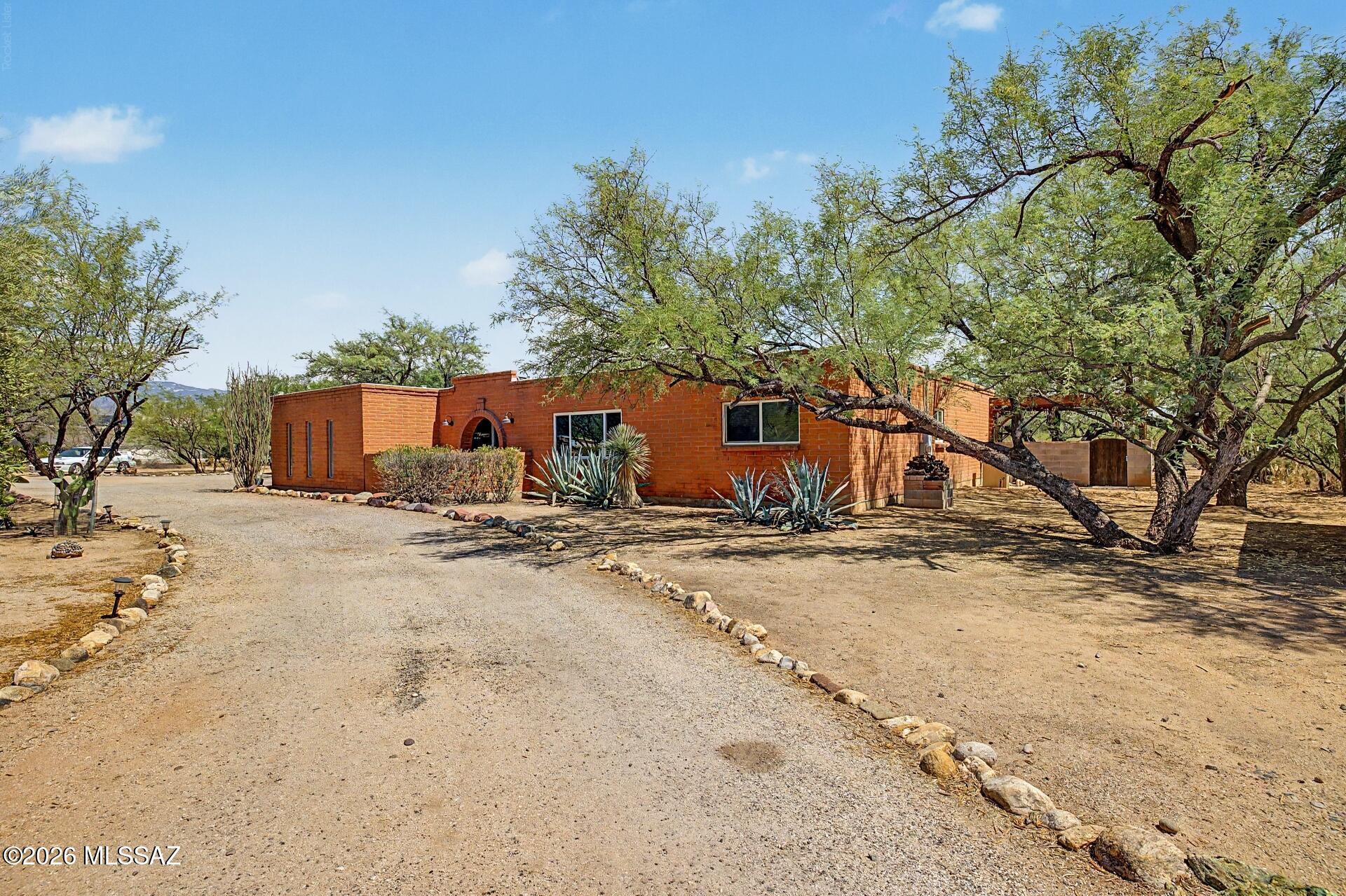 Nestled in the sought-after Bel Air Ranch Estates of the scenic Tanque Verde Valley, this beautifully updated ranch-style home offers peaceful desert living on just under an acre of land. Featuring a spacious split-bedroom floor-plan with 4 bedrooms and 2 baths, this home blends comfort, functionality, and style throughout.

The kitchen features three ovens, a Thermador cooktop, farmhouse sink, generous pantry, abundant cabinetry, and a cozy fireplace the seller will truly miss. The expansive living room showcases stunning Catalina Mountain views, creating the perfect backdrop for relaxing or entertaining.

Outside, enjoy the sparkling PebbleTec pool and the freedom of a large lot with room to add a guest house, workshop, additional garage, or more. Located within the highly acclaimed Tanque Verde School District and featuring a voluntary HOA, this well-appointed property is packed with amenities and opportunity.

Experience the charm, space, and serenity this exceptional home has to offer!