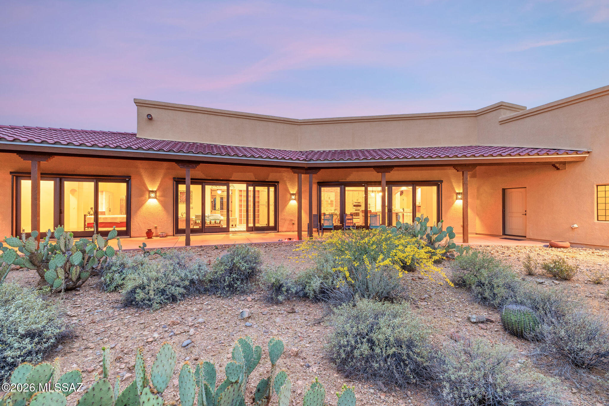 Set along iconic Happy Trail, where the name perfectly reflects the lifestyle, this extraordinary custom estate offers a rare blend of luxury, privacy, and authentic Sonoran Desert beauty! Situated on 3.3 acres bordering the breathtaking landscape of Saguaro National Park, this is a one-of-a-kind opportunity to own a home where the surroundings are as impressive as the residence itself. Offered for the very first time, the home showcases impeccable pride of ownership and thoughtful design throughout. Towering saguaros, untouched desert flora, and sweeping natural vistas create a setting that feels both expansive and deeply serene. This is an environment that simply cannot be replicated! Inside, the residence features a highly desirable split floor plan, enhanced by a private casita on one end--perfect for guests, multigenerational living, or a secluded retreat. Soaring ceilings and polished concrete floors bring a modern, refined edge while maintaining a warm connection to the desert surroundings.
The kitchen is both functional and inviting, appointed with rich knotty alder cabinetry and granite countertops--designed for both everyday living and effortless entertaining! Thoughtful upgrades elevate the home's efficiency and security, including rolling shutters and a premium fiberglass front door that makes a striking first impression. The property also features owned solar, helping to significantly reduce utility expenses while supporting sustainable living. Quiet, private, and incredibly peaceful, this estate offers a lifestyle defined by space, beauty, and tranquility. Whether you're enjoying golden desert sunsets or the stillness of a star-filled sky, every moment here feels intentional.
Homes of this caliber, in a location this special, rarely come to market. Welcome to Happy Trail--where elevated desert living begins! Ask about adjacent lot for sale for even more privacy!