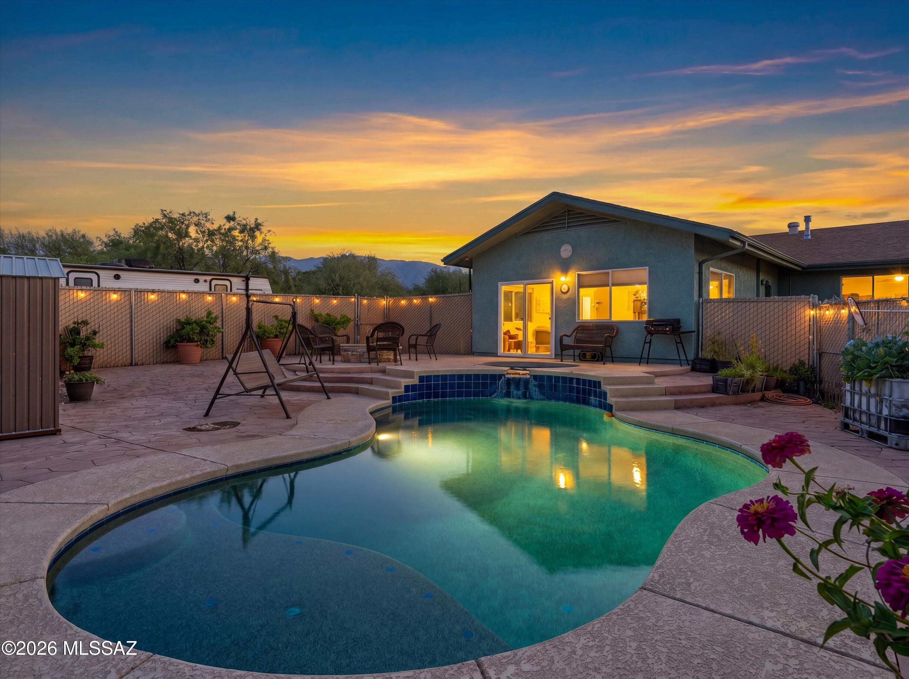 Discover a private desert retreat perched on over an acre of land, offering breathtaking panoramic views of the surrounding mountains. This thoughtfully expanded home features professionally permitted additions, including a spacious great room that opens seamlessly to an exceptional outdoor living area.
Outdoors, enjoy resort-style amenities including a pool, spa, and gas fire pit--perfect for entertaining or relaxing while taking in the spectacular scenery.
The property is enhanced by 17 mature fruit trees, including peach, fig, and citrus varieties, creating a lush, productive landscape. Additional features include RV parking with water and electrical hookups, two storage sheds, and a rainwater harvesting system. NEW interior paint and Newer HVAC system.
