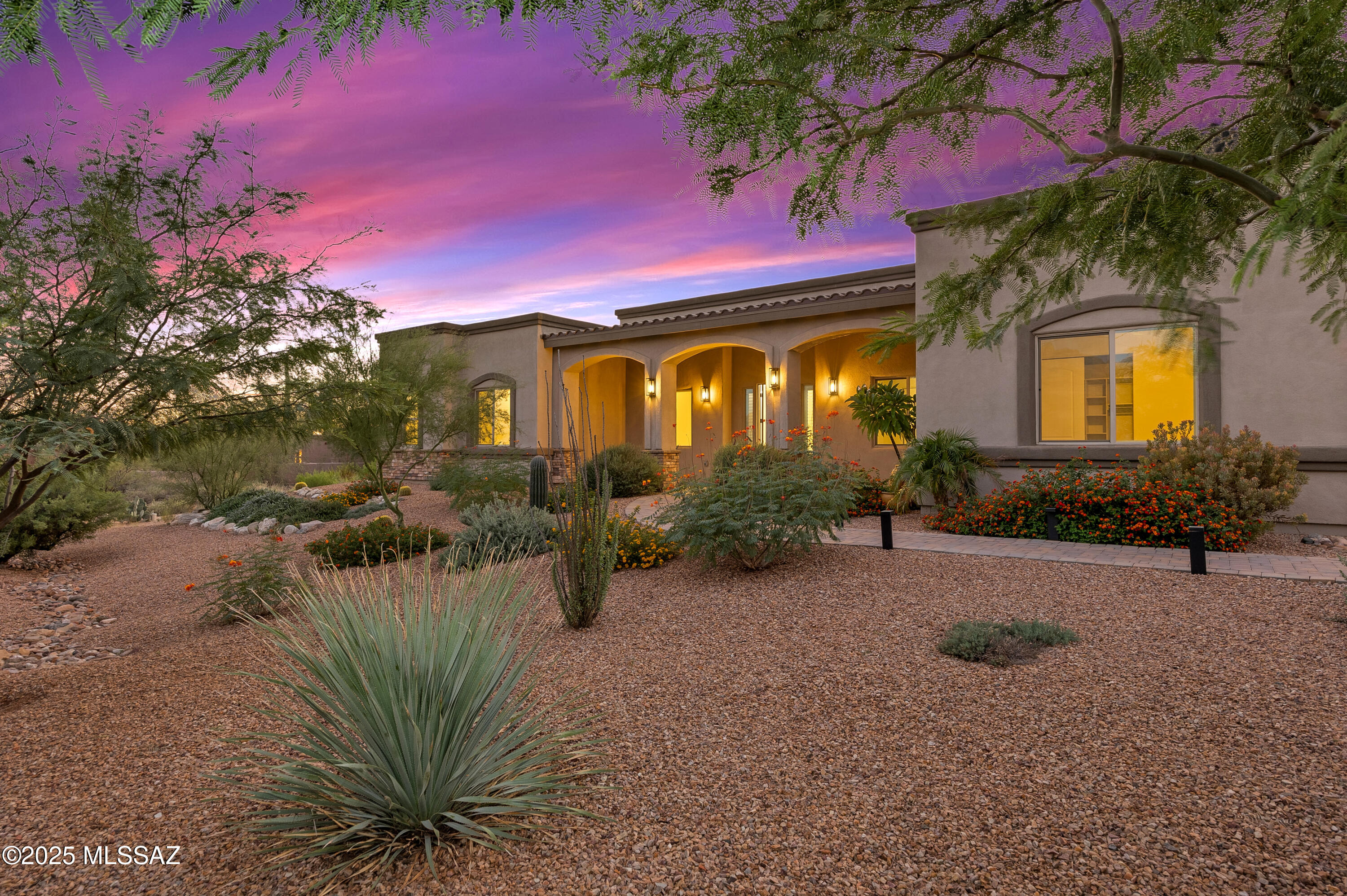 Open House Saturday 4/4 from 10:00 to 12:30 pm! Significant Price Improvement!  Great Value!  Stunning 2.6-acre property. This 3-year-new custom home blends elegance, quality, and comfort throughout. The expansive great room offers a versatile layout with stylish porcelain tile flooring. 12-ft ceilings throughout.   The gourmet chef's kitchen features upgraded cabinetry, quartz countertops, premium Café stainless appliances--including a smart gas range with convection oven and hood, built-in microwave, and refrigerator. A large center island with seating for six and an impressive walk-in pantry completes the space. The owner's suite is a private retreat with a sitting area, spa-like bath featuring double vanities, a soaking tub,  .  See ''More'' comments. extended walk-in shower, and  huge walk-in closet. Two additional en suite bedrooms each offer private bathrooms, providing comfort and privacy for family or guests. An oversized four-car garage with state-of-the-art rubberized flooring ensures plenty of space for vehicles, storage, or hobbies. Step outside to take in the stunning backyard views stretching across the valley. A perfect setting for peaceful outdoor living.  4th bedroom/office with large walk-in closet is versatile for any need you may have.  Large Storage shed addition off garage provides ample space seasonal items, camping gear, etc.   This is a premium location close to hiking, shopping, golf, medical facilities and Catalina State Park!  Don't miss the opportunity!