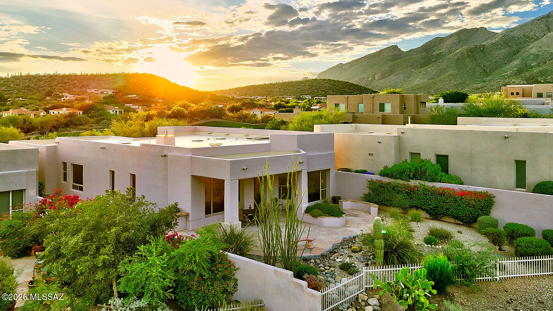 Perched on the Ridge in a gated, highly sought-after Catalina Foothills community, this exceptional home showcases breathtaking Catalina Mountain and Ventana Canyon Golf Course views. Floor-to-ceiling windows frame the scenery and fill the home with natural light, seamlessly bringing the outdoors in. Thoughtful serene architecture is highlighted by travertine flooring, custom paint, and an open, inviting floor plan. A dedicated dining room with a tray ceiling sets the stage for elegant gatherings, while the classic, efficient kitchen features maple cabinetry, granite countertops, quality appliances, and a casual eat-in area. The spacious primary suite offers stunning picture windows, a separate soaking tub and shower, a peaceful retreat. A well-separated guest suite includes an ensuite bath, complemented by a convenient powder room for guests. Step outside to enjoy covered and flagstone patios, a built-in BBQ, and truly endless views,an ideal setting for both quiet evenings and entertaining in one of the Foothills' most desirable locations.