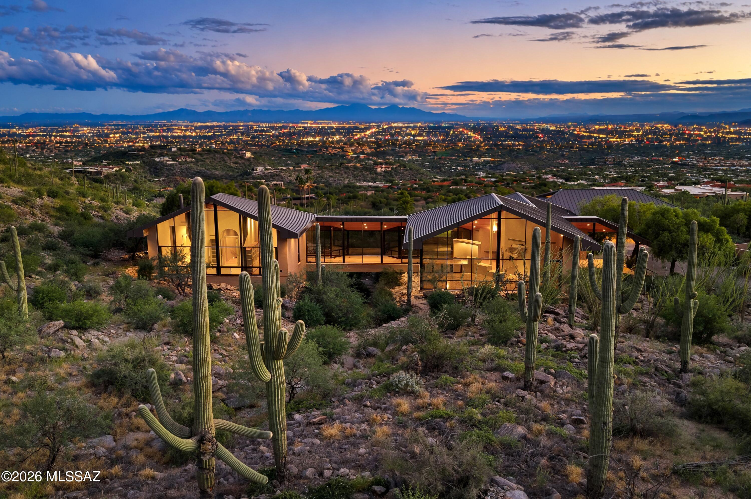 Iconic Tucson Foothills Estate Perfectly Located at The Top of The Prestigious Cobblestone Community. Marked By Significant Architectural Quality, Style, Unparalleled City & Mountain Views & Thousands of Acres of National Forest as its Backyard. This 5BR & 8BA Ron Fridlind-Designed ''Bridge House'' Features Soaring Fir Plank Ceilings, Walls of Glass, Formal Living & Dining Rooms, 12-Seat Theater, Spacious Island Kitchen that Opens to Great Room w/Fireplace and Private Dining Patio. Other Fine Features Include: Separate 1BR & 1BA Guest/Pool House - Separate 8 Car Garage w/ Hydraulic Lift,+ 2,264 SqFt Flexible Space For Gym, Art Studio Etc., & En Suite Staff Qtr's - Pool, Spa,& Turf Yard. Top of The World Away From it All, Yet Minutes From Tucson's Finest Dining, Shopping, and Country Clubs.