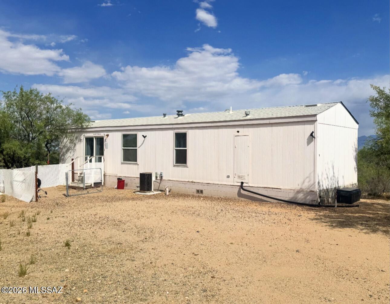 Situated on over 4 private acres, this 1-bedroom, 1-bath manufactured home presents a unique investment opportunity in a peaceful rural setting. Zoned for horses with ample space for corrals, RV parking, trailers, equipment, or future improvements. The property offers privacy, wide-open views, and flexible potential for renovation or redevelopment. Conveniently located within reach of town amenities while still offering the space and seclusion of private desert living. A rare chance for investors or buyers with vision to unlock the full potential of this property.