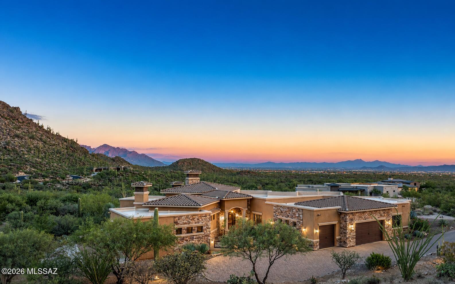 Extraordinary custom Canyon Pass home- exquisite craftsmanship that offers comfortable luxury living. Grand great room concept living - each window highlights a beautiful view. This residence is surrounded by the beauty of the Tortolita & Catalina Mountains, mesmerizing city lights, sunset glows and beautiful morning sunrises. Sprawling porch/patio sitting areas - relax in the glow of the majestic under porch fireplace, enjoy the relaxing pool, host a BBQ, hypnotize yourself in the city lights.  Single story - no steps. Fabulous garage - great for car collectors. 3 beautiful fireplaces - great room, primary bedroom, under porch.  If you love cooking you'll love this gourmet kitchen - and the adjoining entertainers bar has old world charm. All bedrooms are oversized w/private baths.