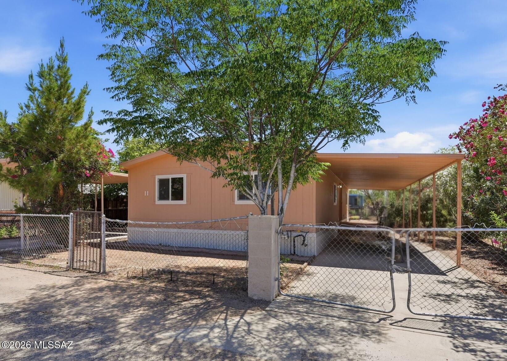 No need to look any further! Just unpack & relax in your completely remodeled home with fully fenced backyard. Kitchen boasts brand-new cabinet & countertops and stainless-steel appliances! Open concept kitchen, dining room & living area makes entertaining easy with plenty of open space. All new laminate & carpet flooring throughout. Both bathrooms feature brand-new cabinets, countertops & fixtures with newly tiled tub surrounds. Large laundry room has extra shelving and built-in storage. Brand-new AC heat pump is ready to keep you cool this summer and the new shingle roof is ready for the monsoons! Both sides of the home have full length covered patios that double as carports. Double chain link gates open to the fenced backyard complete with a large storage shed & mature fruit trees.
