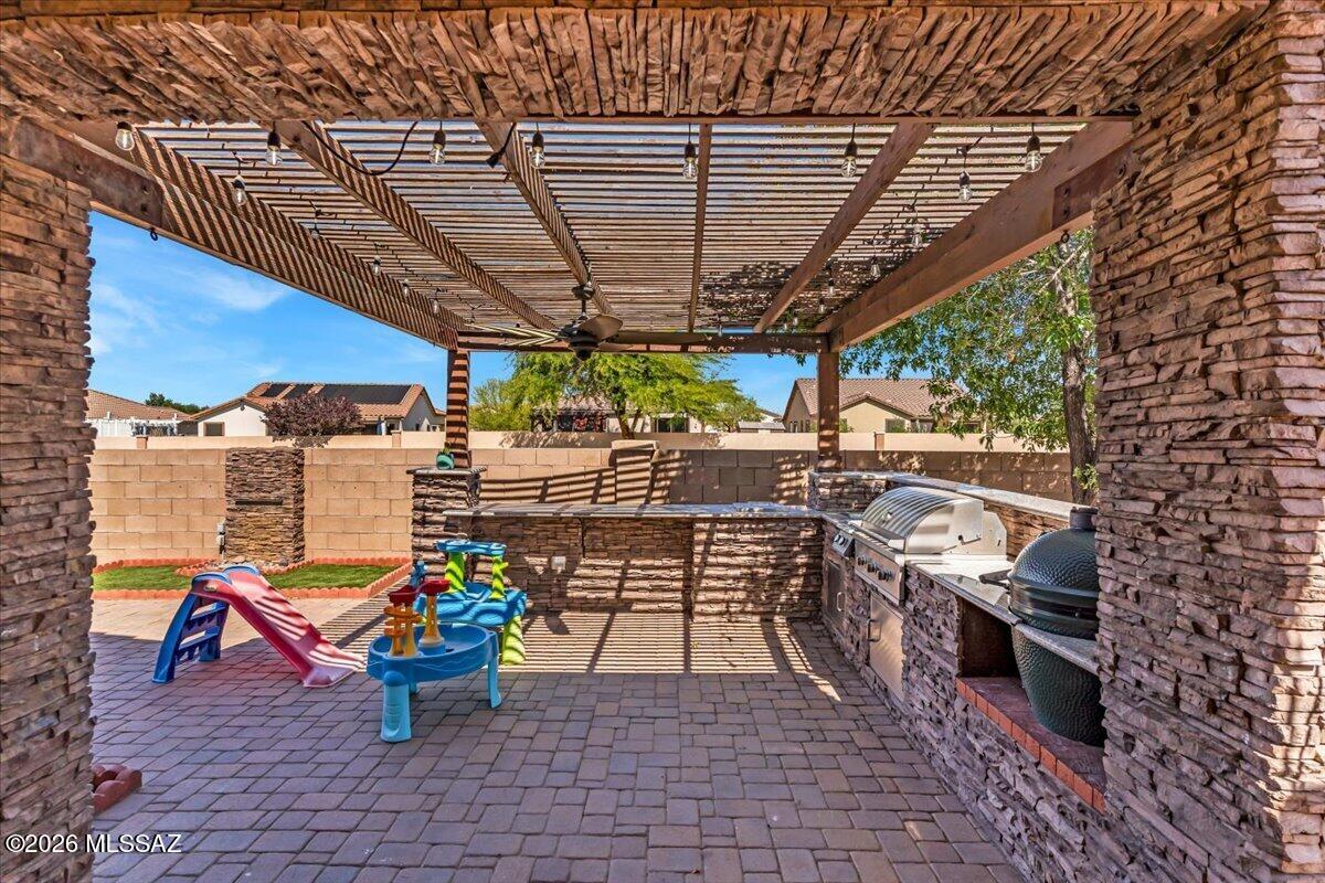 Assumable LOW RATE!
Move-in ready home in Rancho Sahuarita with upgrades you won't find in most homes--plus no rear neighbors for added privacy. Inside, you'll find durable tile flooring throughout the entire home, along with a fully upgraded kitchen featuring a waterfall island countertop, farmhouse sink, wine fridge, and pull-out cabinetry for maximum storage.
The primary suite is a standout with a custom accent wall and TWO cedar-built walk-in closets--perfect for organizing uniforms, gear, and everyday wear. Out back, unwind or entertain with a built-in BBQ, outdoor kitchen, and fireplace in your private backyard space. Located in the master-planned Rancho Sahuarita community, you'll have access to pools, parks, fitness areas, and walking trails-- making it an easy transition for any military family looking for comfort, convenience, and community.
