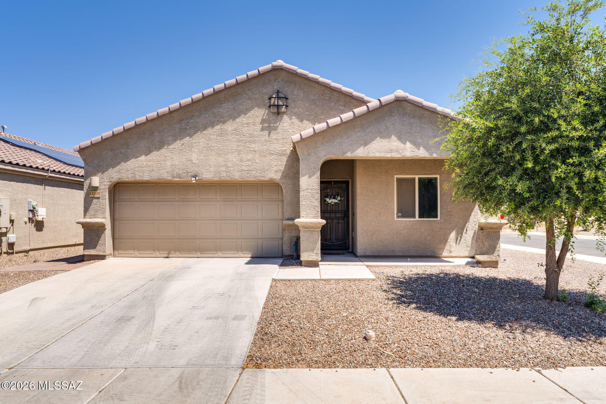Move-in ready home in the sought-after Gladden Farms community! Freshly updated with new carpet & interior paint touch-ups throughout, this home features tile flooring in all main living areas & brand-new carpet in the bedrooms. The spacious kitchen offers granite countertops, a center island, & a large walk-in pantry. Desirable split-bedroom floorplan with 3 bedrooms, 2 bathrooms, plus a versatile den. The spacious primary suite includes dual sinks & separate his-&-her closets. Additional highlights include a 2-car garage & a corner lot. Enjoy the beautifully landscaped backyard featuring an extended paver patio, artificial turf, & included outdoor furniture with an acceptable offer. Energy-efficient solarsystem installed in 2018 through SunRun with a low monthly lease payment of $100.17 and average TEP billing of approximately $26/month. Home also features a whole house water softener and reverse osmosis at kitchen sink. Residents of Gladden Farms enjoy exceptional community amenities including parks, splash pad, sports courts, and scenic walking trails, all conveniently located nearby.