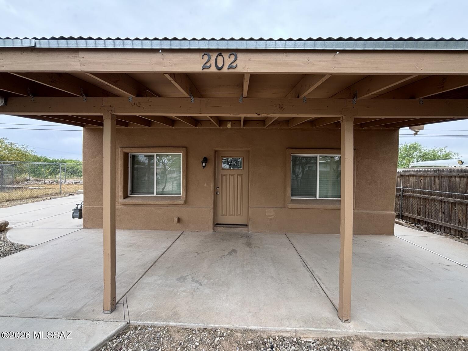 Charming Southwestern stucco home featuring tile floors throughout, neutral finishes, spacious bedrooms, and a functional open layout. Updated kitchen with wood cabinetry, black countertops, stainless steel appliances, pendant lighting, and island. Includes a large laundry/utility room with ample storage, tiled bath, ceiling fans, and a covered front patio/carport.

The property is fully fenced with a private gate, offering added privacy and security. The generous lot also provides space for a potential ADU with the City of Tucson. Pre-approved ADU plans are available through the city, creating a great opportunity for additional living space, rental income, or a guest casita.
