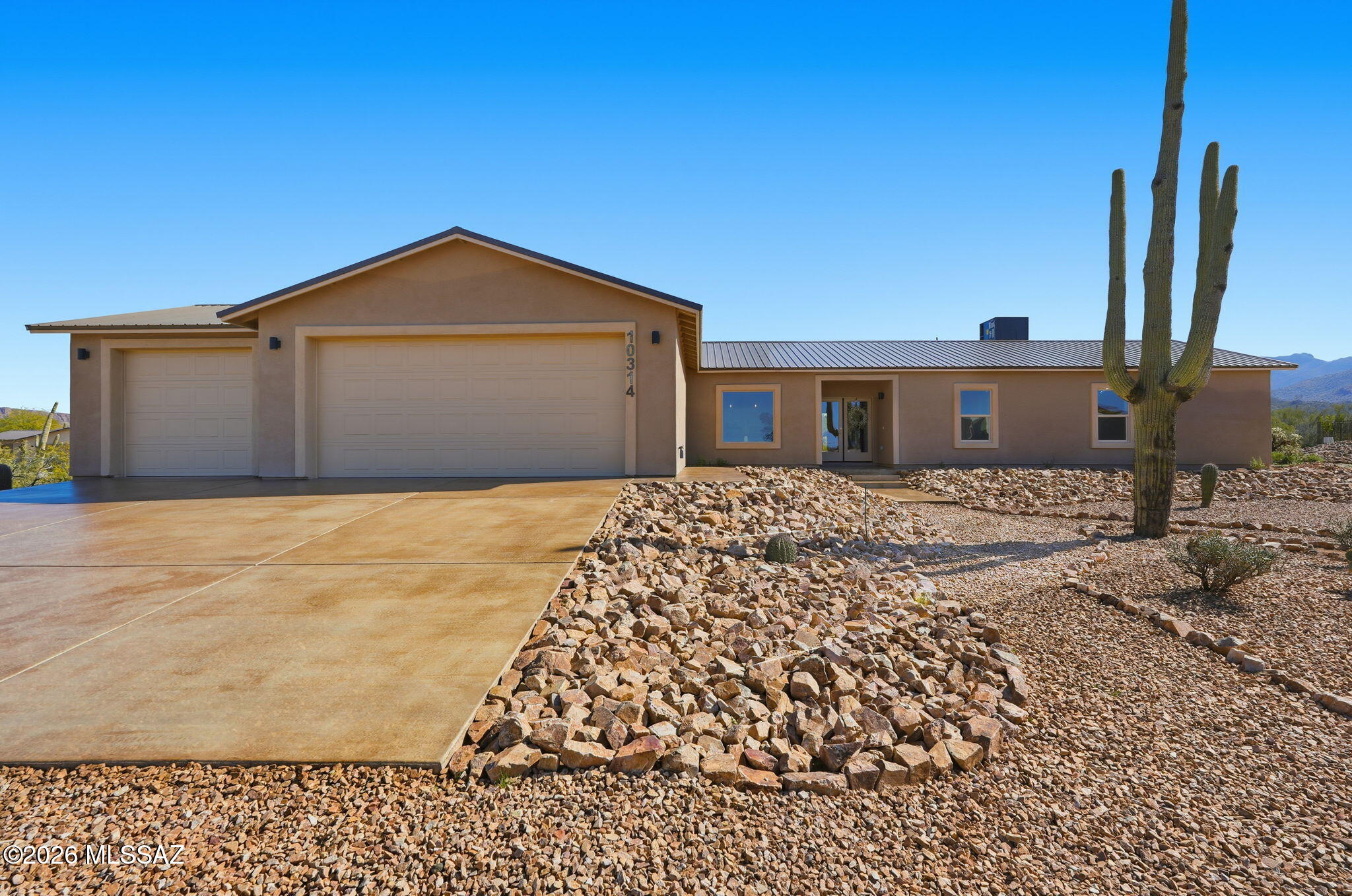 New custom built 4 Bdrm 3.5 bath home with Open floor plan on 1.2 acres. Beautiful sunsets, mountain views breathtaking desert surroundings and an abundance of gorgeous Saguaros. Enjoy this modern home with many luxury features. The kitchen boasts an oversized island with additional dining seating, quartz countertops, pot filler above an electric range, all new stainless steel appliances and custom lighting. Stained concrete floors, soaking tub and beautifully tiled walk in shower in the Primary bath. The 3 car garage offers wired and ready for electric station for your EV, extended length garage and a low maintenance yard. Metal roofing has been a big Hit! Move in ready! Come take a look at your new home! And NO HOA!