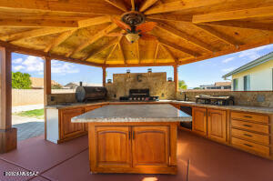 ENTERTAINMENT HAVEN! This 3 bdrm, 2 bth home includes 3 XTRA rooms! Bonus 1st room. Add a wardrobe for an additional bdrm & make it 4! The other 2 can be for multi-use. Cozy family room w/ fireplace & formal dining. Open concept kitchen & living room also perfect for entertaining. Landscaped & irrigated front & large back yard. Beautiful gazebo covering a full outdoor kitchen w/ wall area for a flat screen TV. Ideal place for entertainment! Large spa & bricked in patio area add to the entertainer's dream. Dress it up w/ a nice firepit & furnishings to your taste. And yes, there is a place for your RV! Drive it through the RV gate & park it next to the 2 multi-use storage sheds. Come out & bring your imagination, bring an offer, and bring your guests!