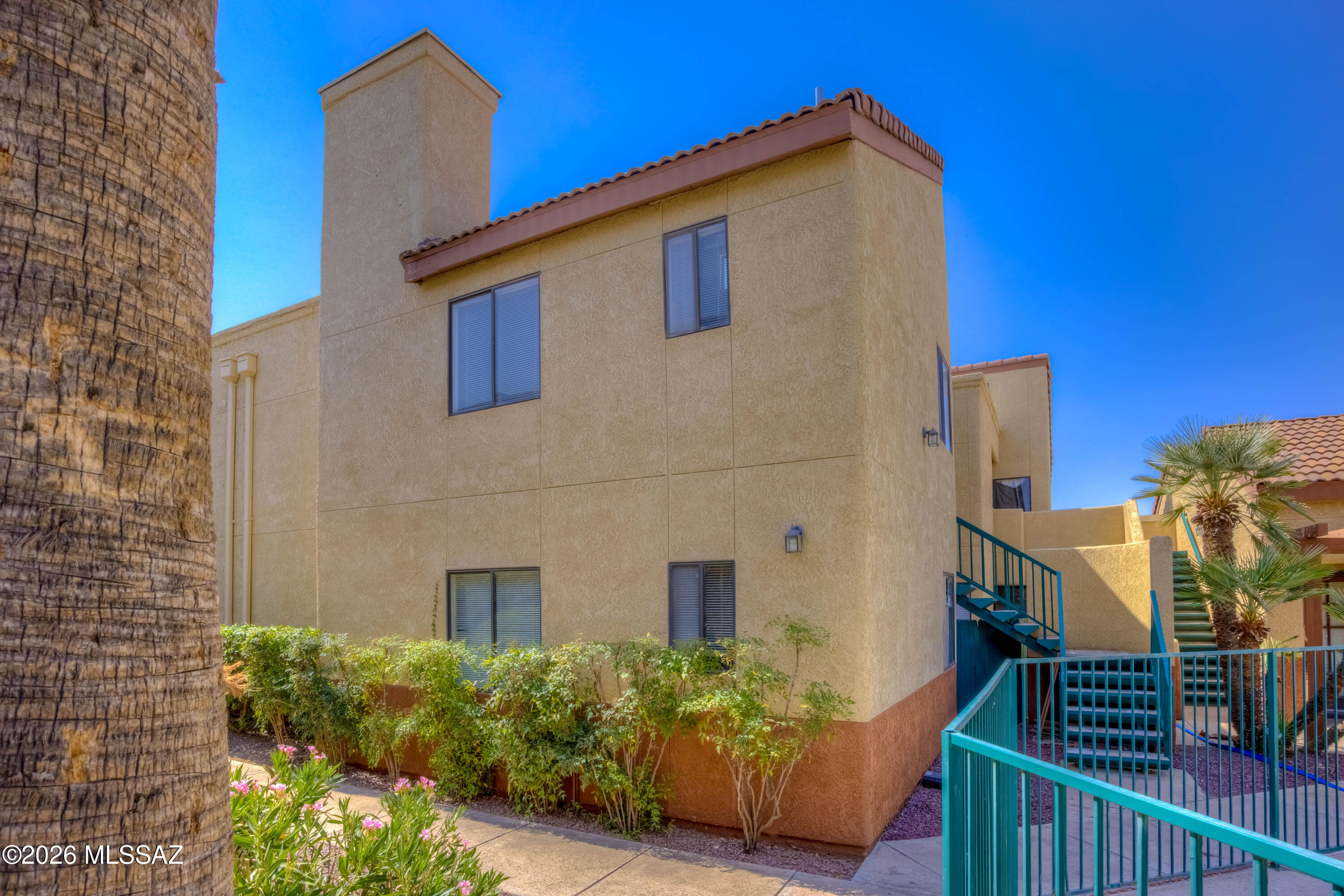 $10,000 Price Drop!! Here's 3 THINGS WE LOVE ABOUT THIS CONDO: 1)High ceilings and lots of light 2)The Location 3) THE Price!  Vaulted ceilings, a wood-burning fireplace, and large windows create an open, airy feel the moment you walk in. The split-bedroom floor plan provides great privacy, with each bedroom featuring its own en-suite bathroom and walk-in closet. Enjoy this central Tucson location just minutes from the Tucson Racquet and Fitness Club, The Loop, The U of A and the Bike Boulevard for easy commuting. Plus the community pool is right outside your door. Whether you're a first-time buyer, student, or investor, this is a smart opportunity to own in a prime location at a great price.
