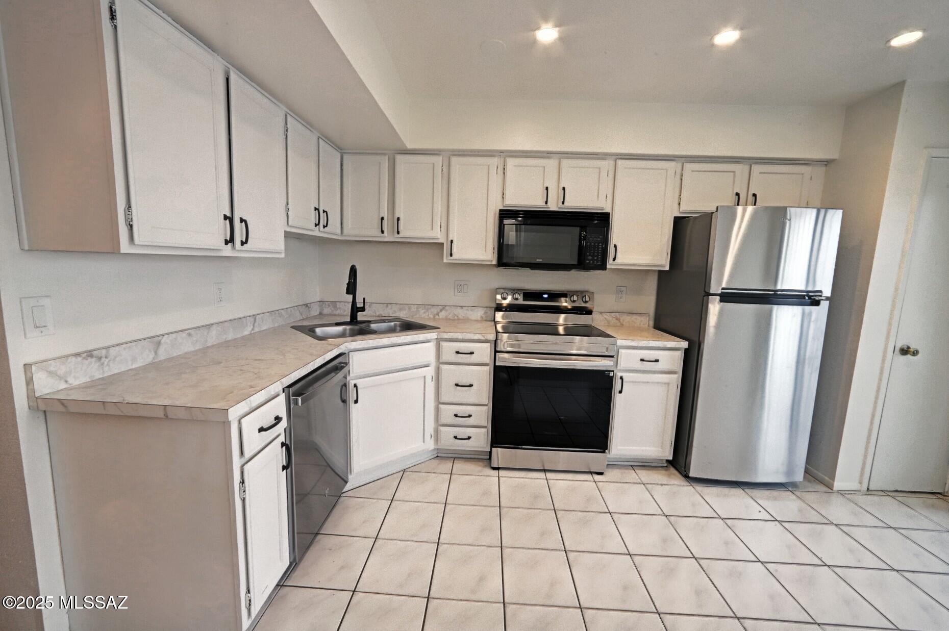 Lovely 2 bedroom, 2 bath condo. Updated with tile flooring through out the lower level and carpet upstairs. Newer appliances including washer and dryer.  Large bedrooms with plenty of closet space upstairs. One bedroom has mountain views, the other overlooks the pool area.  Full bath upstairs, 3/4 bath downstairs.  Delightful patio area for enjoying morning coffee or evening get- togethers with friends.  Close to shopping, dining, U of A and Pima college downtown.  A fun place to live!