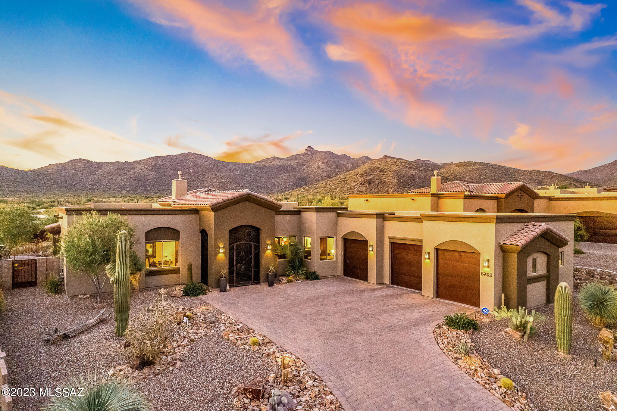 Welcome to this Elegant 3 bedroom plus den Miramonte home situated in the prestigious gated community of Boulder Bridge Pass in Dove Mountain. This customized open floor plan features Viga beams and wood plank ceilings, Alder doors throughout, an oversized gas fireplace tiled floor to ceiling with remote control, built-in surround sound, and a long list of upgrades that will not go unnoticed as you enter this sophisticated home. Located on a premium lot, the open floor plan showcases the unobstructed views of the Tortolita mountains and the 1st fairway of the Ritz Carlton Dove Mountain Golf Course with two sliding glass doors and upgraded Andersen windows on the North side of the home. The gourmet kitchen allows you to entertain in style equipped with 2 kitchen islands, top-of-the-line Granite, upgraded Monogram appliances, a prep sink, a wine fridge, 2 under counter refrigerator drawers, 2 ovens, a gas range, and exceptional views. The extended Primary Suite features the outdoors with gorgeous views, sliding glass doors to the back patio, built-in surround sound, a walk-in shower featuring upgraded tile, top-end granite, large vanity, an oversized walk-in closet with ample space, and soft close drawers. A pocket door inside the primary closet leads to the well-equipped laundry room that can be accessed through the den/office as well. The second bedroom is ensuite with a walk-in shower, upgraded tile, dual sinks, and top-end granite. The third bedroom has an extended walk-in closet that can accommodate all your storage needs. An extended 3-car garage hosts custom storage cabinets, a Culligan water softener, an enlarged water heater, and an epoxied floor. Lastly, enjoy your fully enclosed portico at the front entrance and rolling screens which completely enclose the extended back patio as you enjoy the outdoors to your beautifully landscaped yard and pristine views. Once you step foot in this home won't want to leave. A complete list of upgrades will be provided upon request.