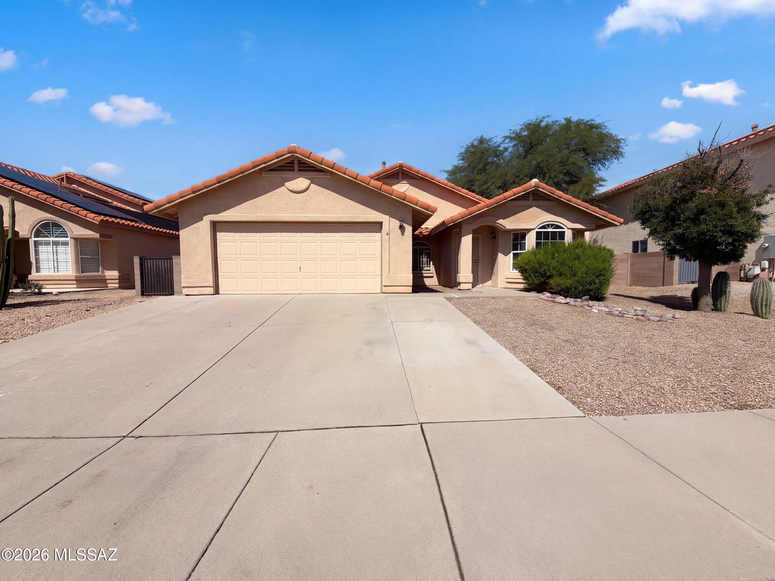 INCREDIBLE BUYER INCENTIVES: $5,000 MORTGAGE CONCESSION. Seller will pay up to $5,000 at closing towards your interest rate buydown if you finance with lender of sellers choice.

3113 W Corte Olivia is a one-story Tucson home with 1,937 square feet of living area. The kitchen has a peninsula, a window over the sink and cabinet storage along the cooking wall. An arched bay window defines the front living room, while an interior archway marks the transition toward the kitchen. The primary suite includes a walk-in closet and a bathroom with two sinks, a separate shower and a tub beneath a window. Outside, a covered patio faces a backyard with a curved paver path, planting beds and a fountain. Included 100-Day Home Warranty with buyer activation