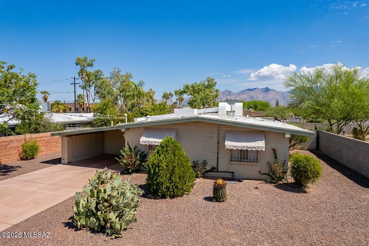 Welcome to your charming, beautifully maintained 3-bedroom, 2-bath home in the heart of Tucson! This inviting residence features a layout illuminated by four skylights for natural lighting. Enjoy a vintage kitchen equipped a fridge, stove, lovely archway adjoining to the kitchenette for your guest. Recent enhancements include a 2009 Installed roof, AC unit,  tile flooring throughout, and fresh paint inside and out. Additional upgrades feature newer sink & toilets, entry and interior doors, ceiling fans, lighting, and window blinds. The landscaped front and backyard include a newer irrigation system, with a paved BBQ area for outdoor entertaining. With a concrete driveway and the property freshly cleaned, this delightful home is move-in ready! Close to TMC and local amenities.