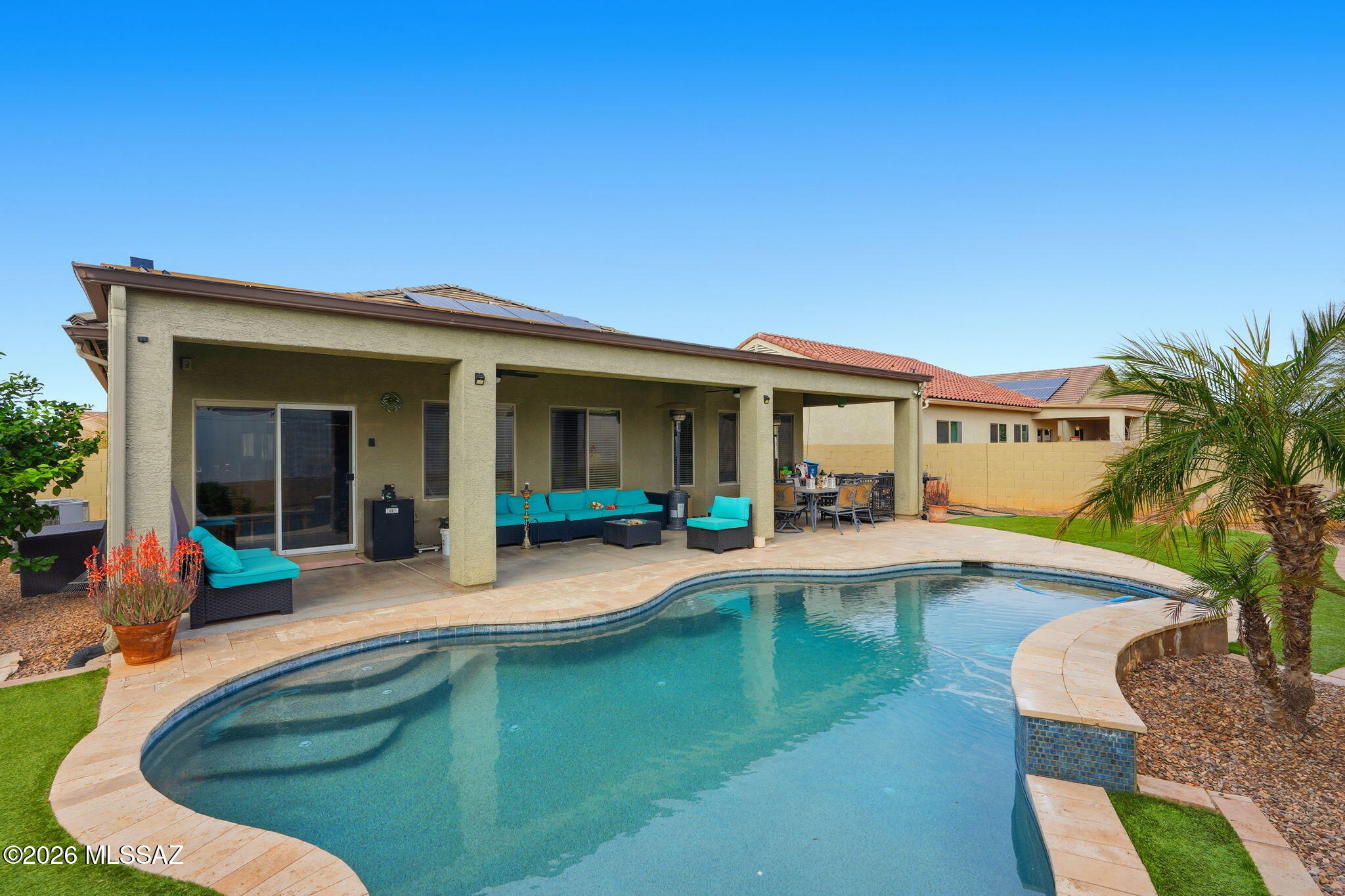 Lots of upgrades! Beautifully landscaped yard. Gorgeous well updated home in Red Rock. Features private sparkling pool with variable speed pump Seller OWNED solar conveys. Providing coverage of most electric usage. Seller indicates the highest electric bill in previous year was  around $110 in the summer. The kitchen has granite counters, pantry and stainless French door fridge. The master has a custom walk in shower. Backyard has turf area, citrus trees, and travertine patio around pool.