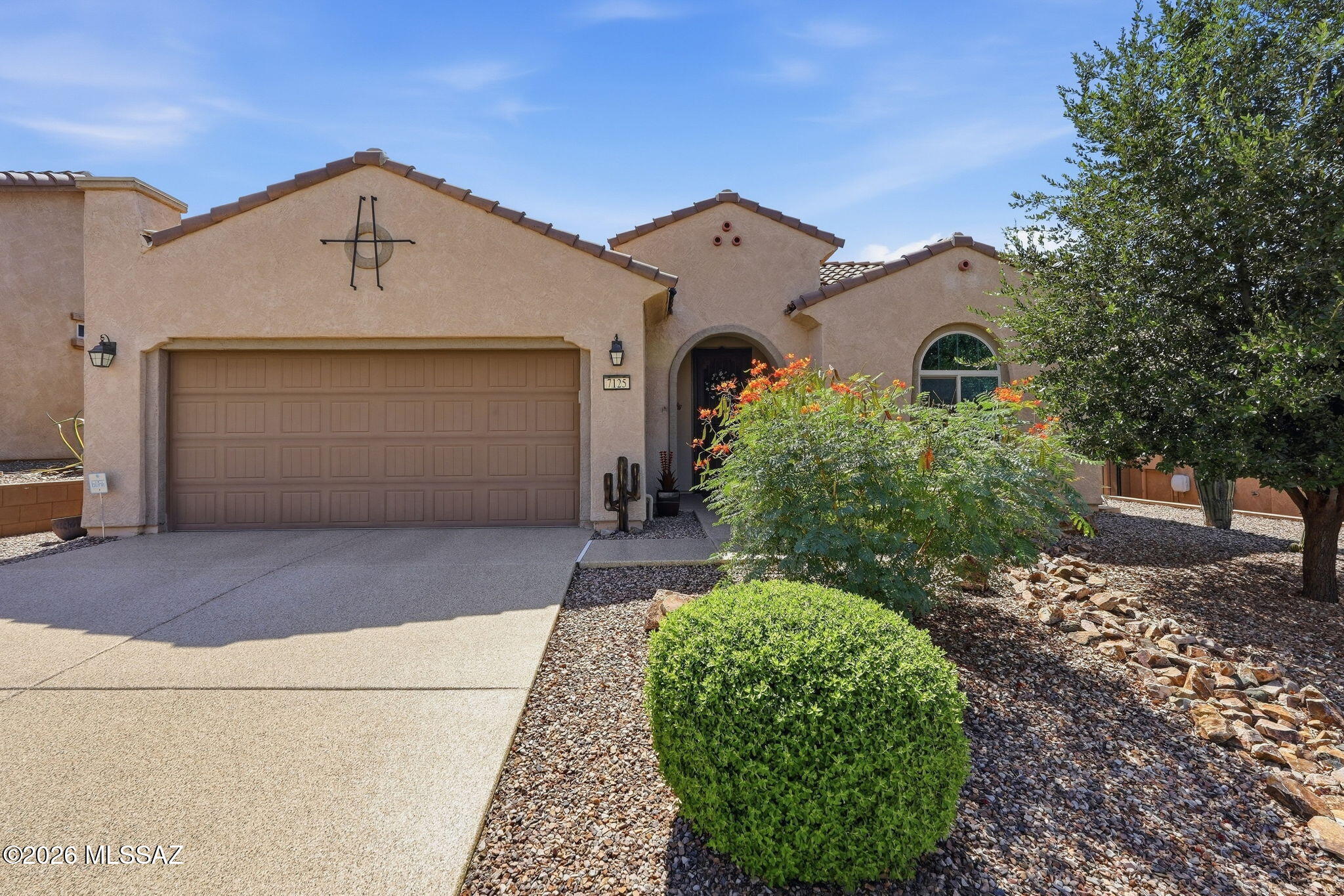 Experience modern comfort and active community living in this exquisite residence situated inside Del Webb at Dove Mountain. This beautifully scaled 2BD/2BA+Office+Air-Conditioned Garage (1,859sqft) Haven model offers a light-filled open great room floor plan wrapped in a crisp, modern palette. Designed masterfully for simple daily routines and casual social gatherings, the common spaces are anchored by a functional kitchen setup that flows seamlessly into the primary dining and living areas. Vast windows frame the interior, drawing a steady stream of Marana's bright high-desert sunshine indoors. The floor plan prioritizes privacy across the sleeping quarters, providing a serene primary retreat alongside versatile guest spaces designed to accommodate out-of-town visitors, home office configurations, or a custom hobby workspace. The indoor common spaces transition smoothly outdoors onto a covered rear patio with automatic rolling screens. The manageable backyard is thoughtfully engineered for low-care decorative desert upkeep. It provides the ultimate, hassle-free backdrop for an easy "lock-and-leave" winter destination, allowing you to spend less time on yard maintenance and more time enjoying morning coffee in the shade against scenic mountain backdrops. Living on River Trail awards you direct, front-row access to a rich master-planned lifestyle. Residents enjoy premium proximity to a state-of-the-art recreation pavilion featuring a resort-style swimming pool, an active fitness center, tennis, putting greens, and high-energy pickleball courts. Balanced by nearby walking trails and luxury dining at The Ritz-Carlton, Dove Mountain, this property is an absolute high-desert gem.