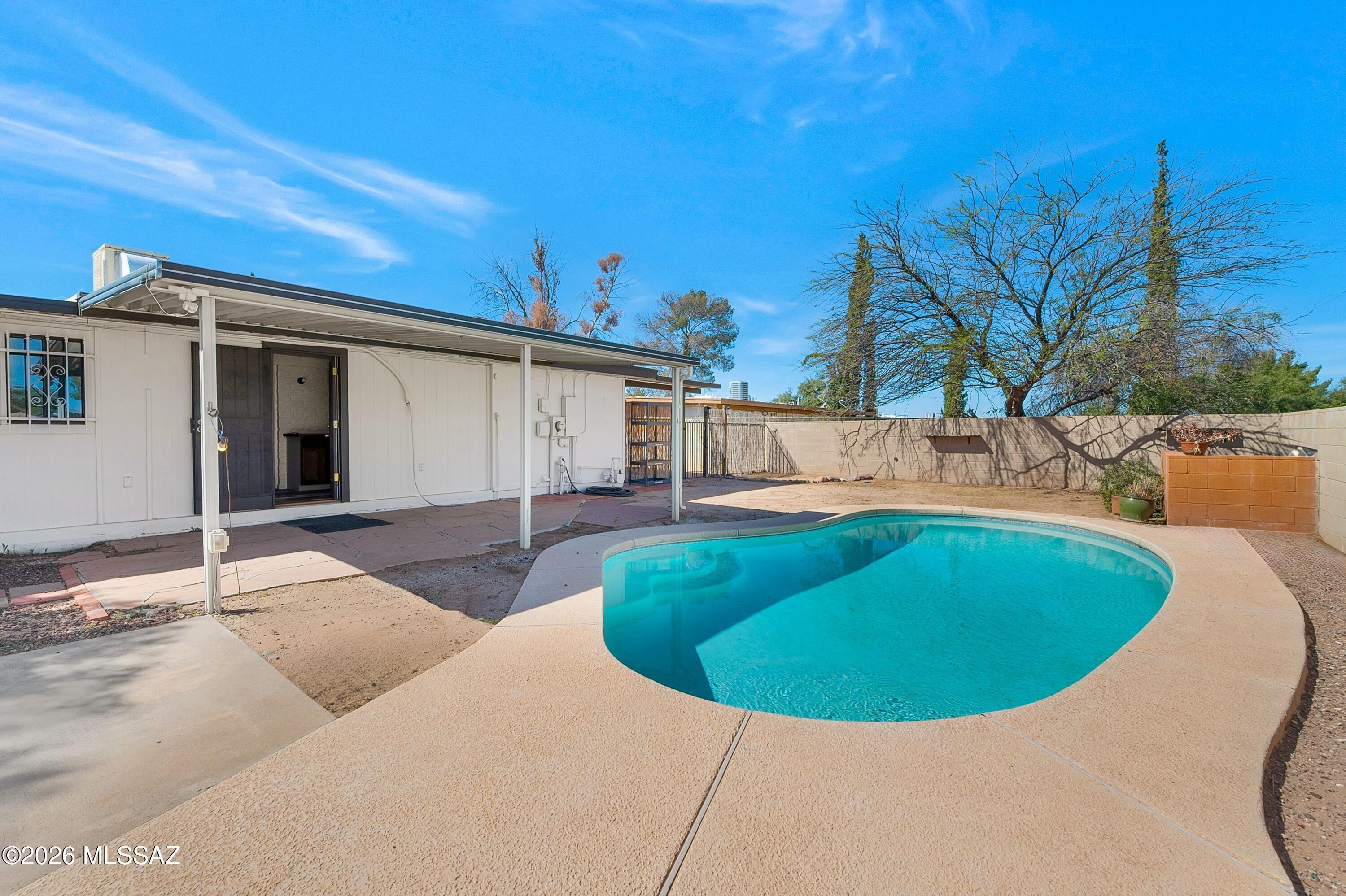 Welcome to a beautifully refreshed and truly move-in ready 4-bedroom home that perfectly blends comfort, style, and functionality--set on a fully fenced lot complete with a sparkling private pool, ideal for enjoying Arizona's sunny lifestyle year-round. From the moment you arrive, you'll appreciate the pride of ownership and thoughtful upgrades that make this home stand out. Featuring fresh exterior and interior paint, brand-new vinyl wood-look flooring throughout, and updated windows, this property offers a modern, clean aesthetic with low-maintenance living in mind. Step inside to a warm and inviting living room where exposed beams, a soothing color palette, and abundant natural light create a relaxing yet stylish atmosphere. A convenient dry bar enhances the space, making it perfect for entertaining guests or enjoying quiet evenings at home. The formal dining area is illuminated by charming skylights, bringing in natural light that enhances every gathering. The kitchen is both functional and spacious, offering built-in appliances, ample white cabinetry, and generous storage. Just off the kitchen, you'll find a versatile bonus room that can be utilized as a walk-in pantry, additional storage, or even a prep space--adding flexibility to suit your lifestyle needs. The thoughtfully converted carport now serves as a fully enclosed fourth bedroom complete with heating and cooling, making it ideal for guests, a home office, or multi-generational living. Throughout the home, you'll find tasteful upgrades including new vanities, toilets, and updated shower and tub fixtures, ensuring a fresh and modern feel in every space. Mini skylights placed throughout the home further enhance the interior with an abundance of natural light, creating a bright and welcoming environment. Step outside to your own private backyard retreat--featuring an expansive covered patio with beautiful flagstone pavers, a refreshing pool perfect for cooling off during warm Arizona summers, and stunning mountain views that provide a serene backdrop. The yard offers a clean canvas for customization, whether you envision lush landscaping, outdoor entertaining spaces, or simply a peaceful escape. Additional highlights include a concrete driveway with extra parking space for multiple vehicles and added storage options, providing both convenience and practicality. This turn-key property truly has it all--style, space, upgrades, and outdoor enjoyment--all in one incredible package. Don't miss your opportunity to own a home that offers both everyday comfort and exceptional entertaining potential. Schedule your private showing today and experience everything this exceptional home has to offer.