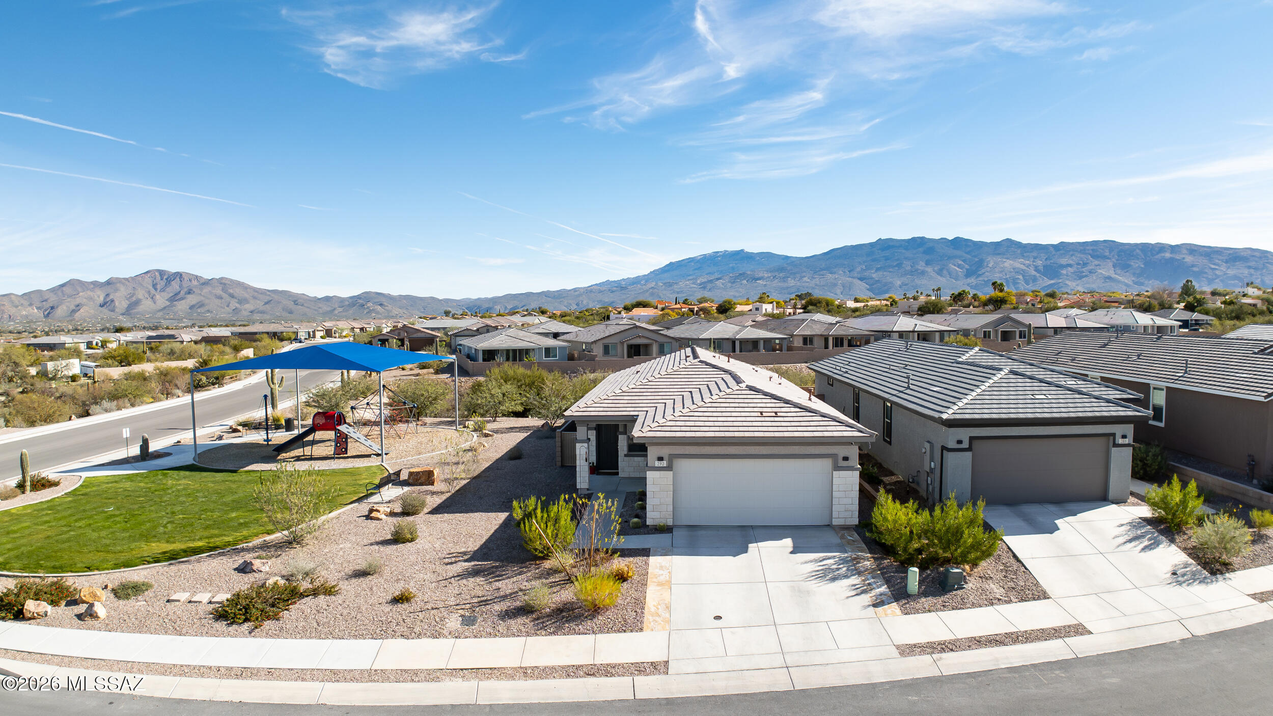 Built in 2024, this exceptional Meritage home is perfectly positioned on a premium corner lot in the gated community of Houghton Reserve, offering rare privacy with no neighbor to the side or rear. Backing to common area and located directly next to a playground park, the setting is both peaceful and vibrant, with sweeping views of two stunning mountain ranges that can be enjoyed from the home and backyard.
Designed with an open and functional floorplan, this 3-bedroom, 2-bath + Den residence is filled with natural light and thoughtful upgrades throughout. The kitchen features granite countertops, stainless steel appliances, upgraded Chrome Delta faucet, R/O tap, and a large island. Ceramic tile flooring, ceiling fans, and recessed lighting enhance the modern, move-in-ready feel The owners have completed a fully landscaped backyard, creating a low-maintenance outdoor retreat with artificial turf, pavers, and decorative gravel-perfect for relaxing or enjoying the mountain backdrop. Flagstone pavers were installed to widen the driveway. Additional highlights include Energy Star-rated appliances, smart garage door, smart thermostat, video doorbell, security cameras, washer and dryer, and refrigerator all included. Permanent exterior LED string lights add to the ambiance.  The community offers walking trails, parks, and the benefit of remaining builder warranties for added peace of mind.
A rare opportunity to own a nearly new home with incredible views, privacy, and a prime location in one of the area's most desirable gated communities.