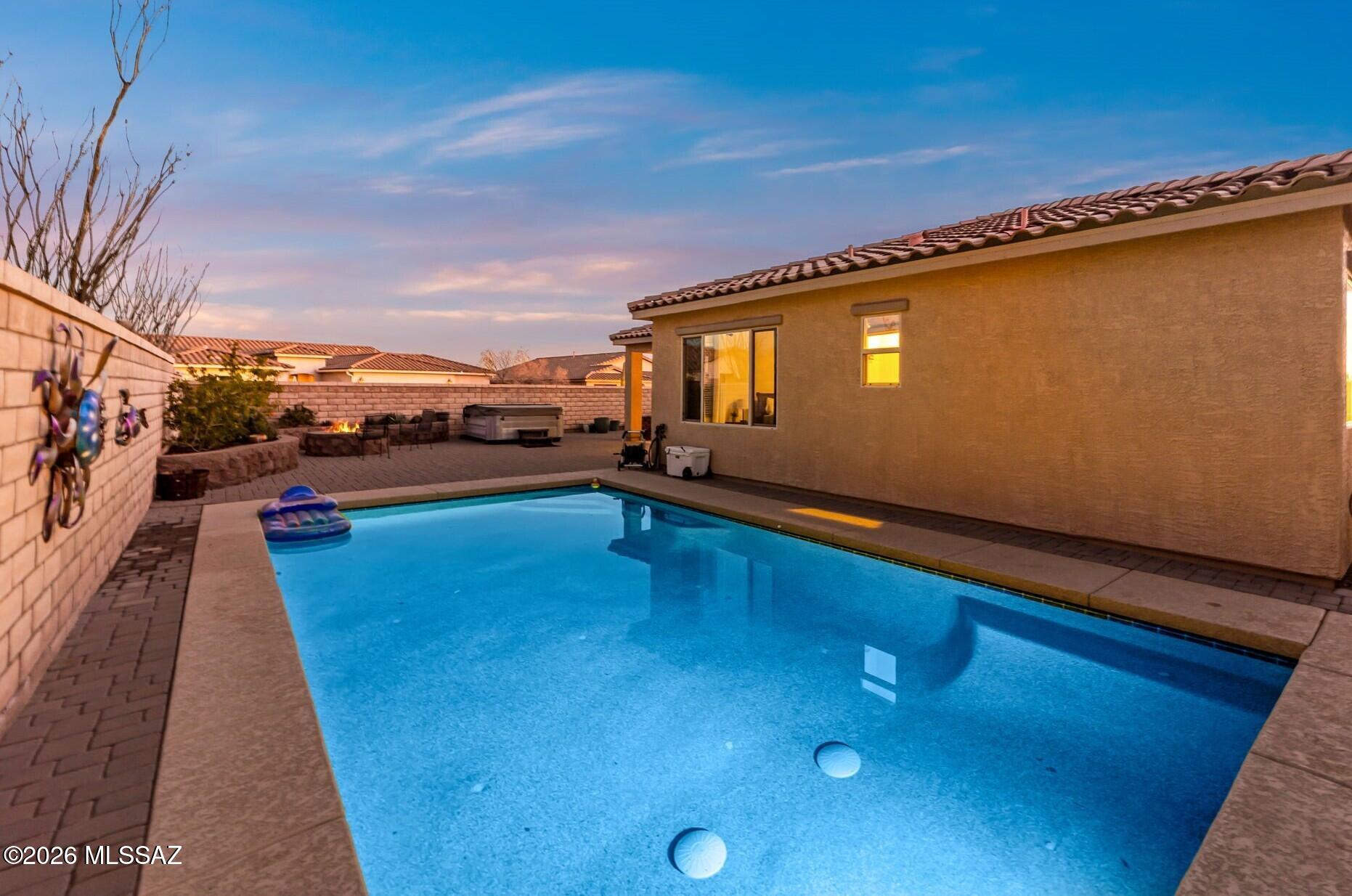Introducing a perfect blend of comfort and contemporary living, this beautifully well appointed residence is thoughtfully positioned in the desirable SkyRanch gated community on a desirable corner homesite, offering both privacy and space. 
From the moment you enter you can see the care and quality this home has to offer. 
A spacious den and a flex space add to the appeal of the floorplan. 
A spacious great room designed to balance everyday livability with effortless entertaining.
The kitchen serves as the heart of the home, showcasing a generous center island  that brings together functionality and clean-lined style for both casual gatherings and culinary creativity.
High ceilings and ample natural light are abundant. The private primary suite is a peaceful retreat, and a spa-inspired bath complete with a separate shower and soaking tub that makes it an inviting space to relax and recharge.
Outdoors, the property is landscaped with garden space and is designed for year-round enjoyment. a sparkling pool, expansive paver-finished surfaces, and a covered patio ideal for alfresco dining, quiet mornings, or evenings spent under the Arizona sky.
Thoughtfully composed and beautifully maintained, this home offers a seamless blend of indoor comfort and outdoor tranquility. An inviting sanctuary designed to elevate everyday living.