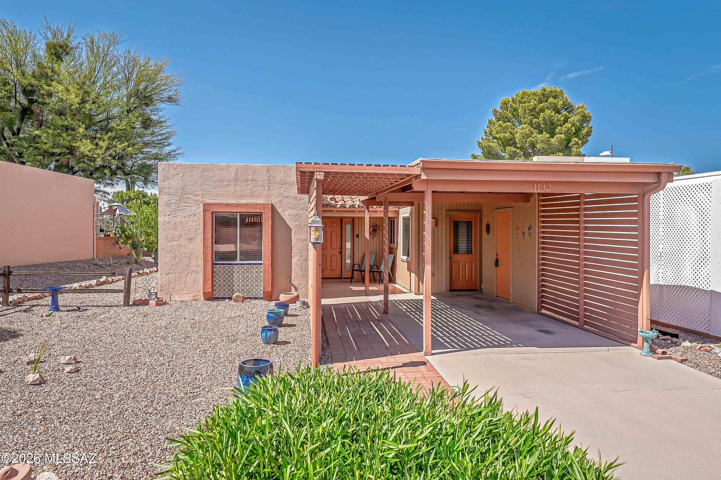 Embrace the Green Valley lifestyle in this lovely 2-bedroom, 2-bath end-unit townhome, where pride of ownership shines through, low-maintenance living comes easy, and the backyard offers a wonderful sense of privacy. Tile flooring throughout, updated windows, a roof recoated in 2024, plenty of storage, and no direct rear neighbor make this home easy to enjoy from the moment you move in. The comfortable living and dining area opens through a sliding glass door to the backyard, creating an easy connection between indoor and outdoor living. The kitchen offers a cozy breakfast nook and all appliances, creating a comfortable and practical space for everyday meals.   The spacious owner's suite includes two closets and an en-suite bathroom with a walk-in shower. Your guests will feel right at home with a comfortable guest bedroom and a guest bathroom featuring a convenient tub/shower combination. The washer and dryer convey with the home, while two additional storage rooms give you ample space for all your extras.  Step outside to a beautiful, low-care backyard with a covered porch and attractive pavers, the perfect spot to sip your morning coffee, unwind with a good book, or simply enjoy Arizona's beautiful weather.  Ideally located near the Desert Meadows Park, with convenient access to I-19, shopping, dining, and everyday necessities. The Green Valley Recreation membership makes this home even more appealing, with access to the incredible amenities including swimming pools, fitness centers, classes, pickleball courts, social activities, and so much more. All around the perfect town home!