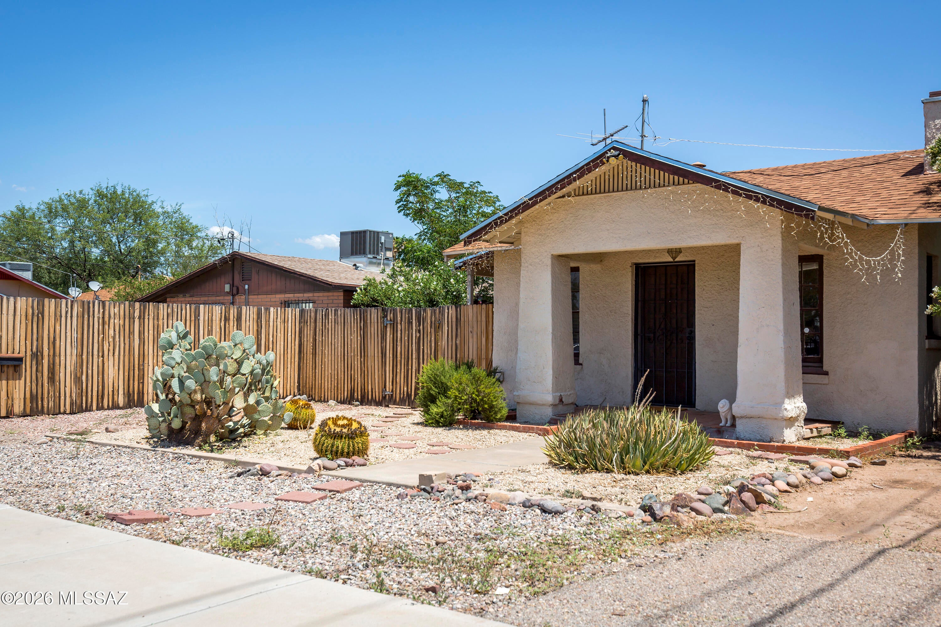 Charming vintage bungalow c. 1927 with a Southwest-style guest house in a prime central Tucson location near the University of Arizona. The 867 sq ft main house features a spacious living area with a fireplace niche, French doors, a galley kitchen, two bedrooms, one bath, and two additional office/flex spaces. The later-added, separate and spacious guest house offers one bedroom, a great room, high ceilings, and scored and colored concrete floors. Both homes are full of character and are currently rented, offering an attractive investment opportunity. Off-street parking comfortably accommodates both residences. Conveniently located near the U of A, Downtown Tucson, and the Sunshine Mile.