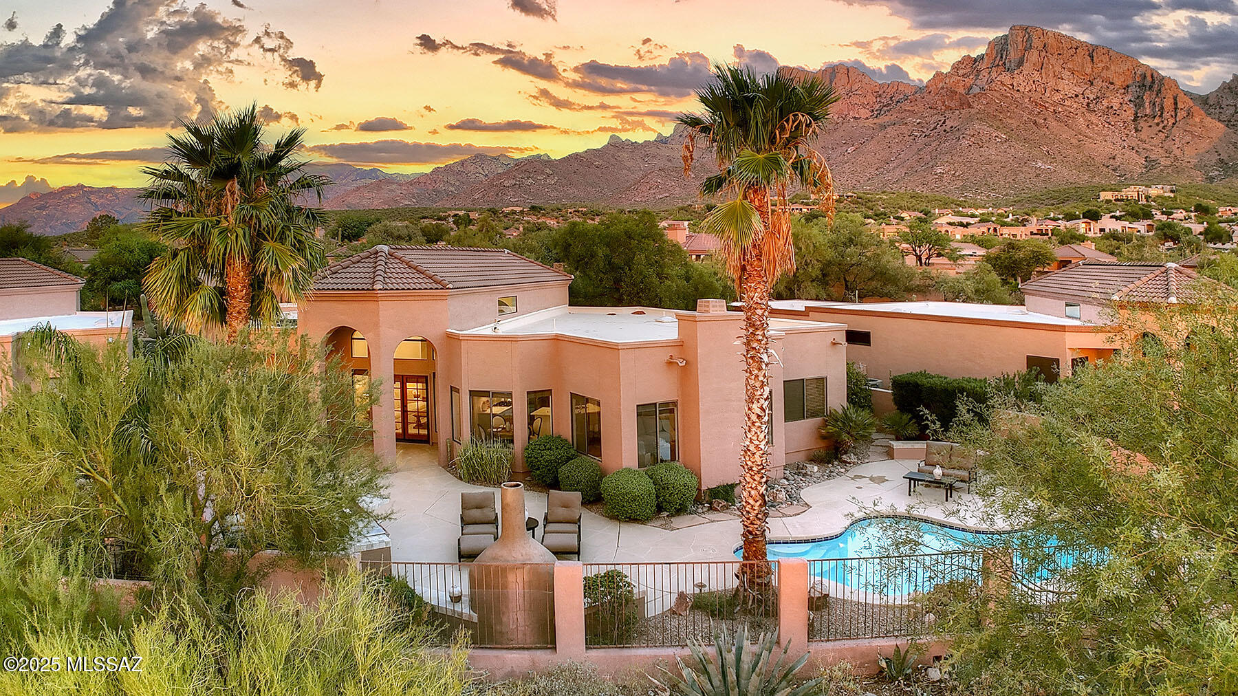 Stunning, fully updated and remodeled retreat with resort-style backyard at the base of the Catalina Mountains and Pusch Ridge.  Set on a premium mountain-view lot in the sought-after, guard-gated community of La Reserve, this 2,292 sq. ft., 3-bedroom, 3-bath home with 2-car garage combines custom craftsmanship with modern finishes and timeless Southwestern charm.  Step inside to discover soaring ceilings, walls of windows, rich knotty alder cabinetry, doors and trim, and scored concrete flooring. The chef's kitchen offers a breakfast bar, abundant storage, quartz countertops, stainless steel appliances including a 6-burner gas cooktop and a wine fridge, all adjacent to the dining room perfect for entertaining guests. A cozy fireplace warms the living room, creating the perfect ambiance on crisp Tucson evenings.  The spacious primary suite features direct access to the back patio, a clerestory window, and a luxurious bathroom with stacked stone surrounds, dual sink vanity with granite counter & oil-rubbed brass fixtures, a soaking tub, a separate shower and walk-in closet with built-ins.  Outdoors, your private desert oasis awaits... all backing up to an expansive common area desert. Enjoy the beautiful back patio offering a porch, a sparkling pool and spa, a built-in BBQ with cooktop, a kiva fireplace with banco seating, and breathtaking sunset views and the dramatic backdrop of the Pusch Ridge mountains.  Updates also include two new HVAC systems, a tankless water heater, new garage door, fully painted interior and exterior, and updated pool electronics.  The Ram's Hill HOA also features a community pool and spa. This home offers the perfect blend of luxury, comfort, and Arizona lifestyle.