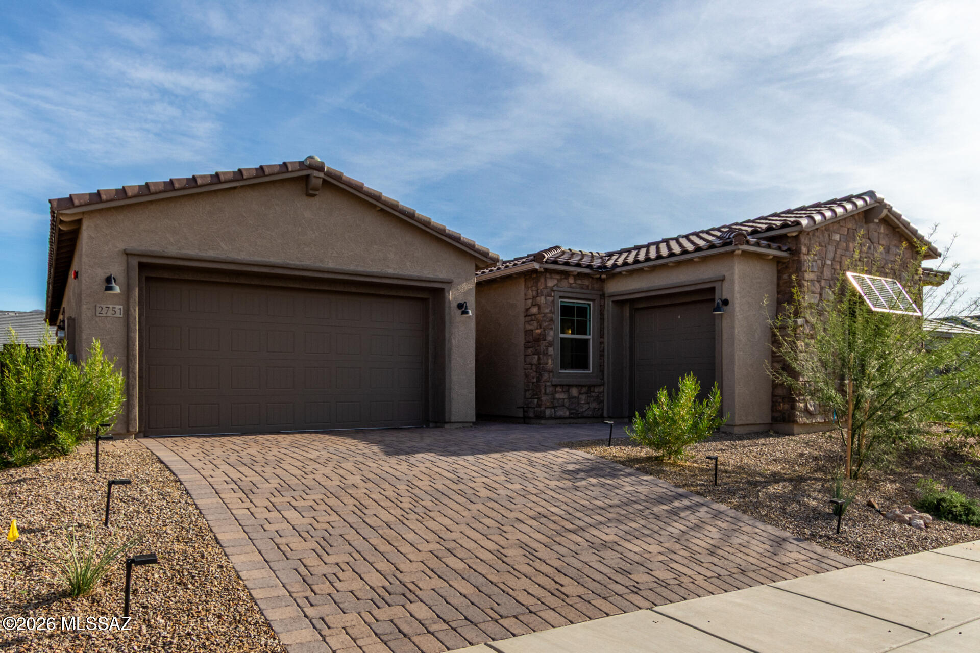Better-than-new 2025 build, fully upgraded and lux move-in ready with smart home features throughout. Less than one year old and still under Pulte builder warranty, this home offers turnkey ease in a gated community with partial Pusch Ridge views. Features 4 bedrooms, 2.5 bathrooms, and a smart 3-car garage.

Inside, an expansive open-concept layout is filled with natural light from oversized windows, complemented by soaring ceilings, recessed lighting, and seamless tile flooring throughout--designed for both everyday comfort and elevated entertaining.

The chef's kitchen is fully upgraded with gas range and exterior venting, quartz countertops, stainless steel appliances, crown-molded cabinetry, a large walk-in pantry, and an oversized island with breakfast bar--built for hosting and daily living alike.

Smart features include motorized shades (blackout in bedrooms), smart thermostats, hardwired Ring doorbell, Yale keypad entry, and a Tesla charger. The 3-car garage offers flexibility and can be converted into an ADU for guest space, income potential, or multigenerational living.

The primary suite is a true retreat with a walk-in closet and spa-style bath featuring dual vanities and a floor-to-ceiling glass tile shower. Secondary bedrooms are generously sized, with a flexible fourth bedroom ideal for office, media, or guests.

Additional upgrades include a tankless water heater, whole-house water softener, and built-in HomeTeam Taexx pest control system with termite warranty.

Outdoor living is dialed in for year-round use with a fully enclosed patio, motorized app-controlled solar shades, and a gas line ready for grill, fire pit, or heater. The backyard also features an irrigated vegetable garden and curated edible landscaping including Oro Blanco grapefruit, Satsuma mandarins, and grapes.

Custom irrigation with dedicated garden lines and a Hunter controller ensures efficient, low-maintenance landscaping.

A rare opportunity to step into a fully finished, high-spec home where everything is already done.