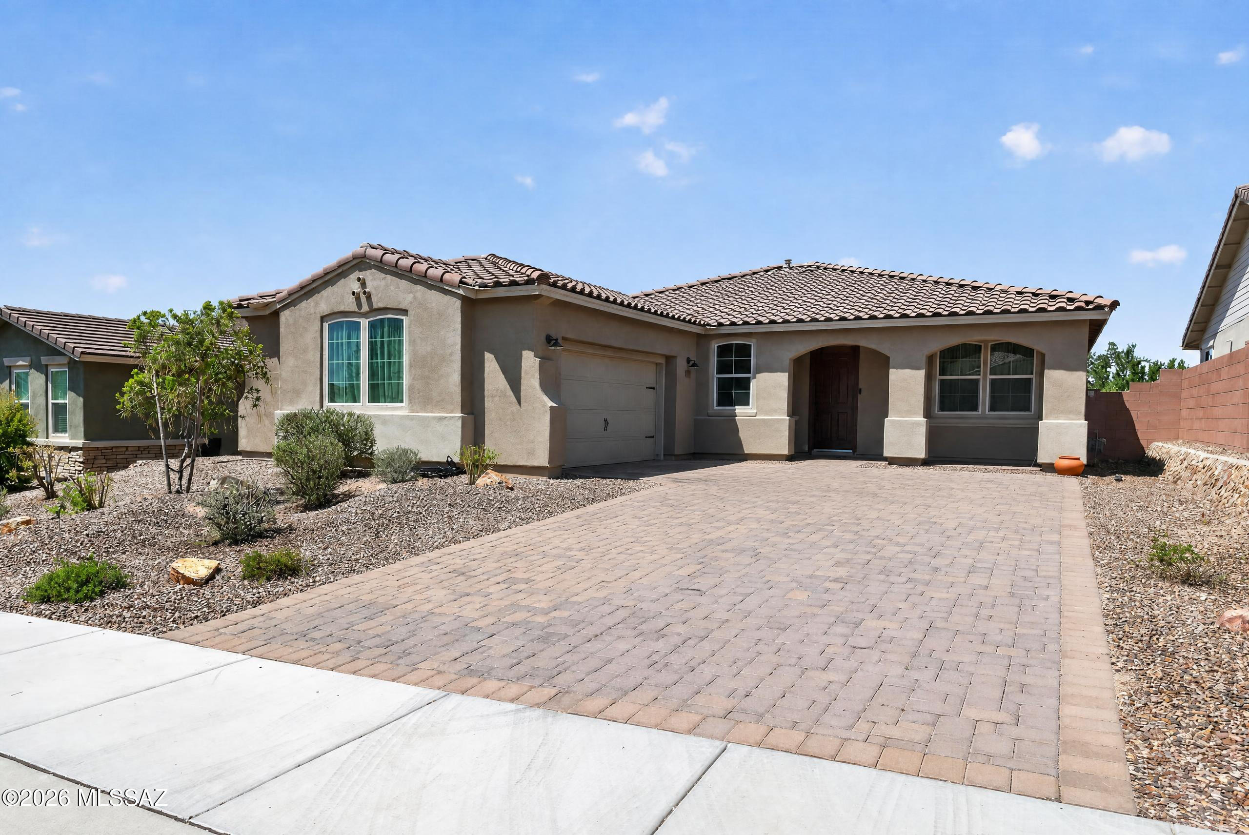 Welcome to this beautifully upgraded Mattamy home located in a gated community in Dove Mountain. This thoughtfully designed two-bedroom plus enclosed den offers an inviting blend of comfort, style, & privacy. The gourmet kitchen features upgraded granite countertops, a tile backsplash, & quality finishes, while the baths include upgraded tile surrounds & a walk-in shower. Additional highlights include 8-foot interior doors, pavers at the front porch, & numerous designer upgrades throughout. The enclosed den provides flexible space for a home office, media room, or additional guest area. Enjoy added privacy with natural desert open space directly behind the home, with no immediate rear neighbor. Conveniently located near scenic trails, golf, dining, & all that Dove Mountain has to offer.