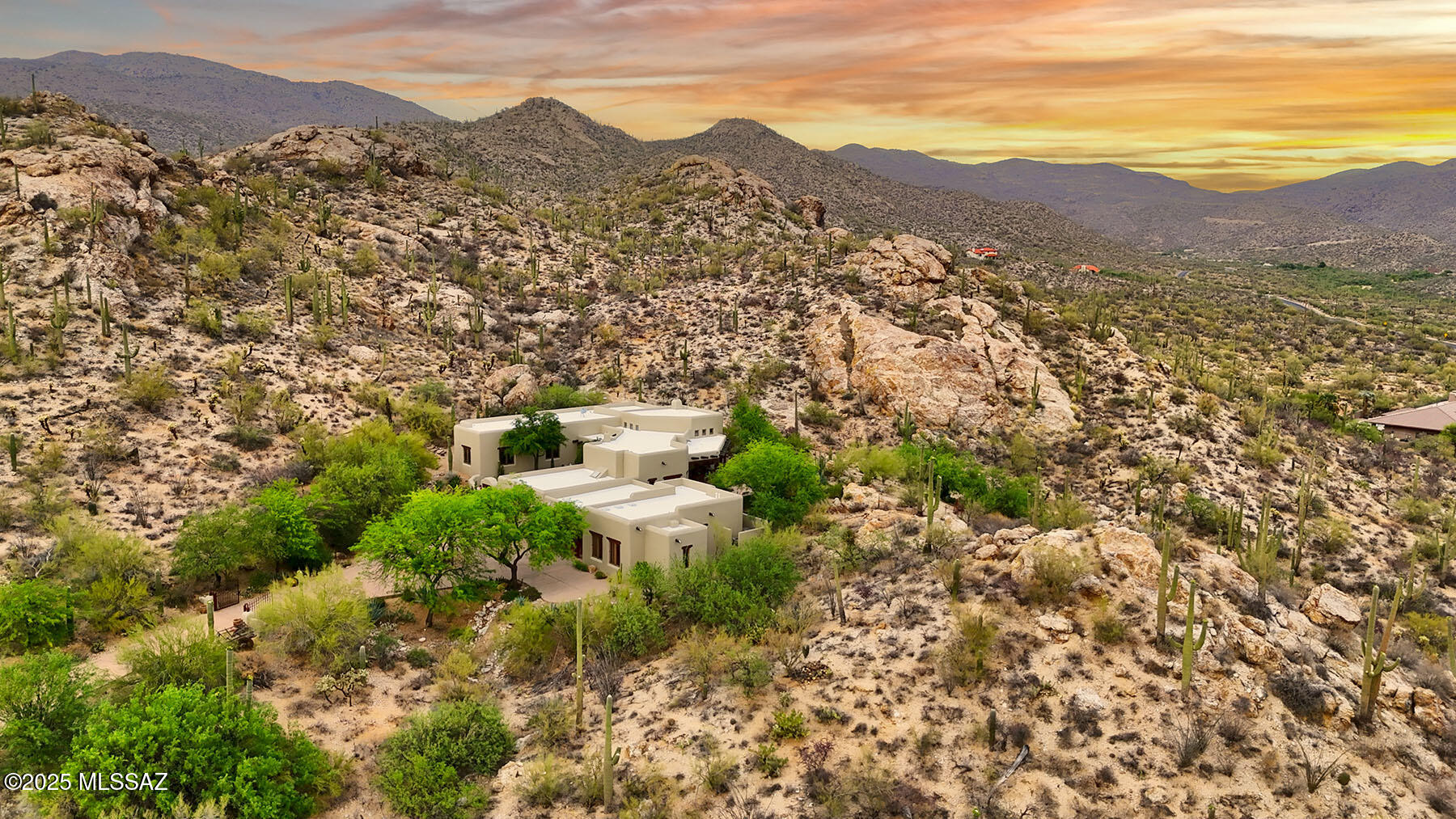 More stunning than words can describe, this architecturally significant mud adobe stucco, Santa Fe-style home by master home builder Mark Butler, leaves no details left to the imagination.  Perched on a hilltop, nestled into the Catalina Mountains with stellar mountain views on 5.93 glorious saguaro studded acres. A long and winding drive leads to the arched entry with wooden lintel and saguaro ribbed gate into the courtyard with fountain and flagstone floor.  If you like southwestern, Santa Fe and rustic, there are no rooms better than this great room — soaring viga ceiling with skip-pealed latillas, hand-adzed lintels and corbels, a charming kiva fireplace, expansive picture windows with enviable Rincon Mountain views.  The generous southwestern-style kitchen offers a beamed ceiling, ceiling, a beehive fireplace with banco seating, Talavera tile counters, saguaro ribbed cabinetry, large center island with a 5-burner gas stove, and a light & bright breakfast nook with a beamed and saguaro ribbed ceiling.  Featured in the main house are 3 bedrooms (den/study could be 3rd bedroom) including a gracious primary suite with dual vanities, soaking tub, separate shower, and dual walk-in closets.  The charming casita offers beamed ceilings, viga columns and corbels, kitchenette and world-class wine cellar.  The glorious and freshly painted exterior has an expansive back porch, a spool built into the hillside and flagstone floors.  Two-car garage, one-car carport, charm, character, unmatched quality, privacy, views and timeless design await you.