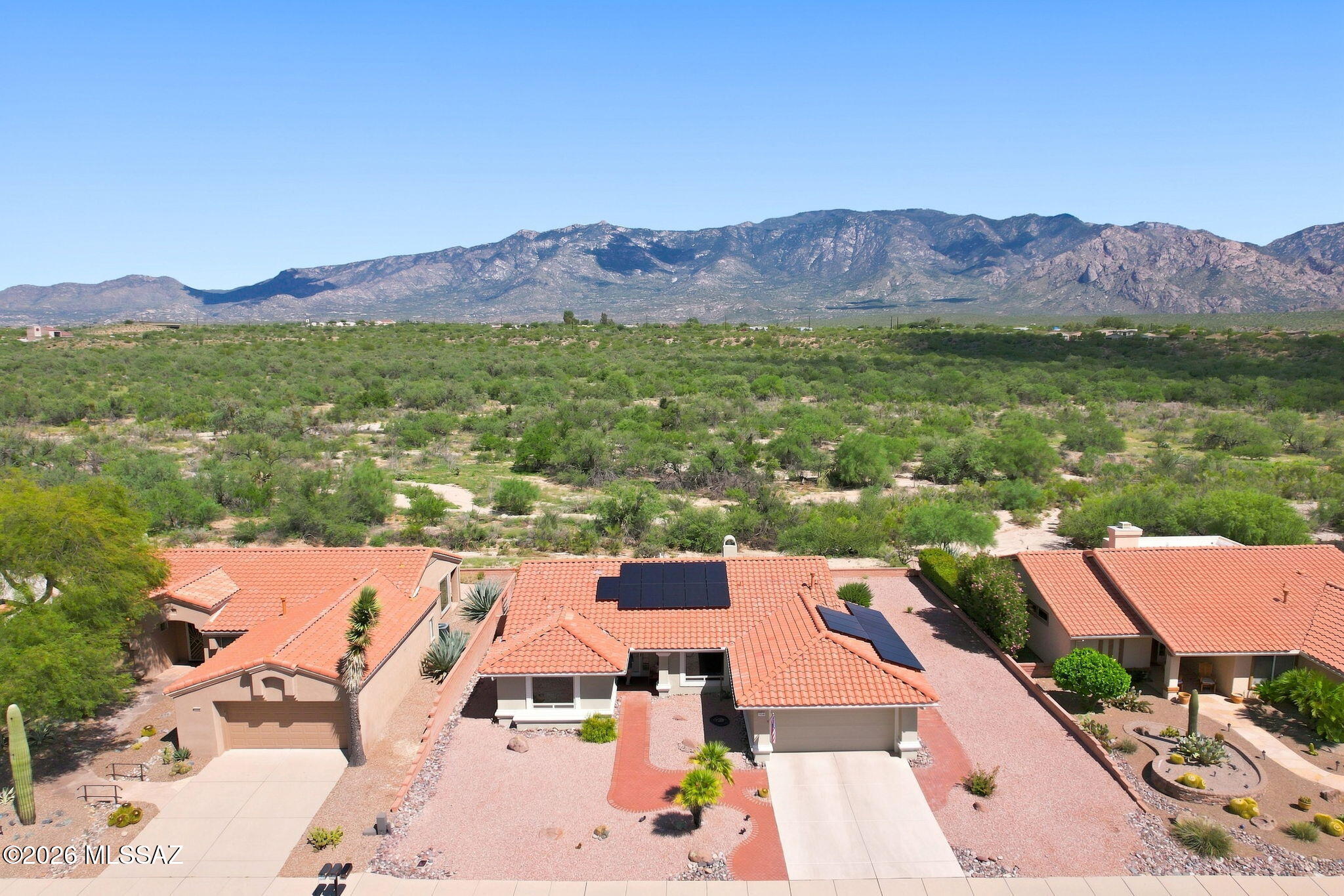 Outstanding Mountain Views! Discover an impeccably upgraded oasis with stunning mountain views in the highly acclaimed Sun City, Oro Valley, a 55+ active adult community. Delivering an incredibly efficient and light-filled floorplan, this 2BD/2BA+office+owned solar+New HVAC system- Extended Sabino Model (1,524-sqft) residence perfectly balances comfort with convenience. Boasting zero interior steps and positioned on a premium lot that backs directly to a pristine, open desert wash, this home is an exceptional choice for a year-round retreat or a hassle-free winter destination. Pass through the inviting entryway into a welcoming interior wrapped in a fresh coat of exterior paint (2026) and a flexible neutral palette. The heart of the home is an expansive great room with unforgettable mountain views. The floor plan flows logically into a dining area and an open kitchen equipped with GE Profile appliances, pull out drawers, and a motion sensor faucet. The dining area is perfect for allowing you to enjoy your morning coffee while gazing out at the natural Sonoran landscape. Working from home or enjoying a creative project is completely seamless thanks to a dedicated den/office/hobby space pre-built with functional custom cabinets and an integrated desk layout. The primary bedroom features generous proportions, extensive closet space, and an en-suite bathroom. The second bedroom serves as an ideal guest sanctuary, sitting just steps from a full secondary hall bathroom that has been updated with Kohler Premier fixtures. The indoor common spaces transition smoothly out to a private, low-maintenance rear patio. Because the backyard sits directly against open desert space with no rear neighbors, you can enjoy ultimate serenity and quiet evenings under the stars. Practical upgrades are found throughout, including a newly updated furnace and A/C unit, a new water heater, and updated widows (Arizona Windows) with double blinds. The 2.5 car garage is extended with built-in storage space, providing extra room for a workshop and golf cart parking. Living on Lobelia Way places an enviable active lifestyle right at your doorstep. Residents enjoy premier neighborhood access to championship golf fairways, resort-style swimming pools, hot tubs, tennis and pickleball complexes, an active fitness center, and vibrant social clubs. Balanced by swift proximity to retail hubs along Rancho Vistoso Boulevard, this home is an absolute treasure!