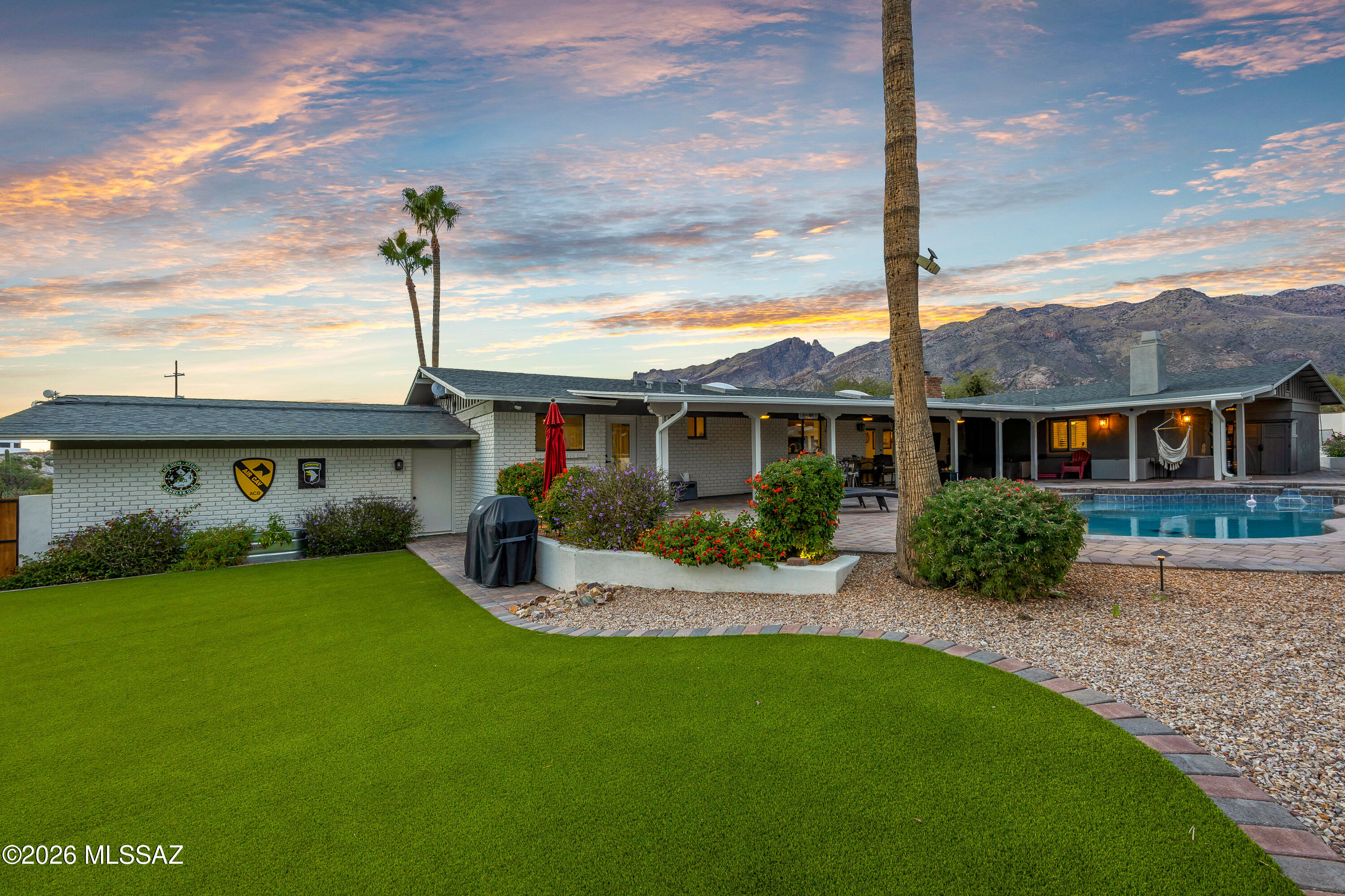 Experience turnkey luxury in this beautifully updated Catalina Foothills residence, where modern design meets comfort. Thoughtfully renovated throughout, this home offers a seamless blend of style and ease with no detail overlooked. And its prime Foothills location is an incredible convenience for the busy professional looking to maximize life.

Step inside to light-filled living spaces, high-end finishes, & a flowing open layout. The chef's kitchen with an oversized island opens to inviting living spaces inside &  out, creating a warm heart of the home. 

The generously sized primary bedroom and ensuite bathroom is the perfect space to begin and end your most productive days. With two closets, flex space for an office, a double sized walk-in shower, soaking tub, gas fireplace and door a picturesque, north facing side yard with fireplace and putting green. It gets better, set on over an acre, with a pool, hot tub, TV area, turf and incredible Foothills views, this property is stunningly landscaped and ideal for entertaining or gazing at the Catalinas, city or stars. 4th bedroom has its own bathroom and door to the exterior - perfect for multigenerational living or more work-from-home professionals. Low HOA fees still allow for a community lap pool, basketball and tennis courts. Wonderful neighborhood for morning or evening strolls. 

The central Foothills location adds quick access to work, dining, shopping, local resorts and golf courses, pristine hiking and cycling, and top notch schools such as District 16, BASIS, The Gregory School & more. Making it perfect for full-time living or a lock-and-leave lifestyle. Proximity to Swan is nicely offset by orientation and size of lot. Best value turnkey acreage in the Foothills.