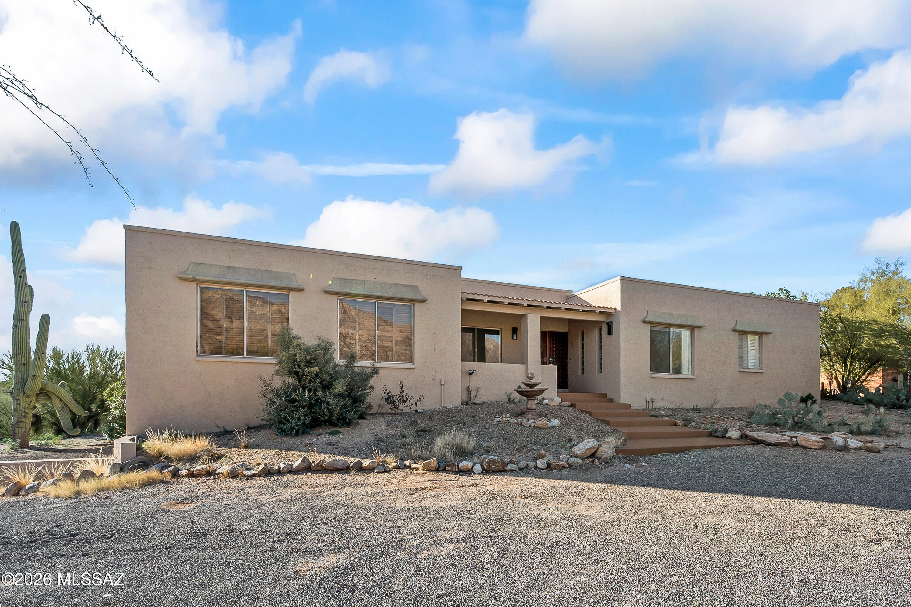 Magnificent mountain and city views from this four-bedroom home in District 16. Great views of the Catalina Mountains from the front of the home. Relax on the pool deck surrounded by bougainvilleas and watch the sun set over Tucson. Two beehive fireplaces and a spacious primary suite. The bay window in the breakfast area frames sweeping city views for your morning coffee. Includes a 400 sq ft studio/exercise/extra bedroom with a high ceiling. Entry foyer leads to a formal living room, dining room, or family room with a beamed ceiling. Great home with tons of potential.