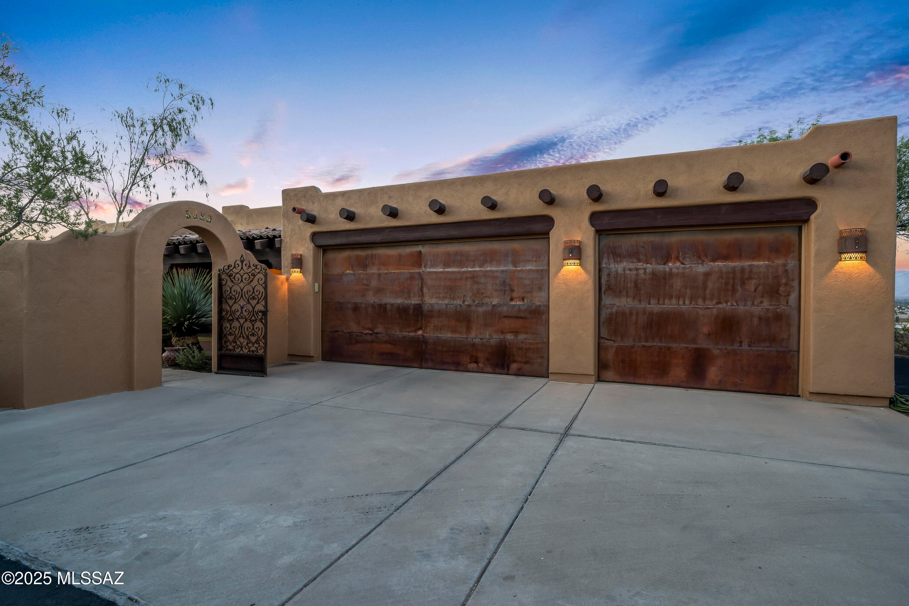 Unique opportunity to experience the magic of the desert in this Santa Fe-style retreat on 3.3 private acres near Saguaro National Park. Surrounded by mountain views and natural beauty, this gated estate offers peace, privacy, and a true connection to the Southwest. Relax on the wrap-around porch, soak in the Pebble Tec spa, or unwind in the screened sitting room while listening to desert birds. Inside, warm wood, tile floors, and expansive windows frame breathtaking vistas. The gourmet kitchen is perfect for gathering, while the elegant primary suite with French doors, stained-glass accents, and spa-like bath creates a serene escape. With guest accommodations, office/den, and timeless Southwest charm, this home offers not just a place to live--but a lifestyle.
