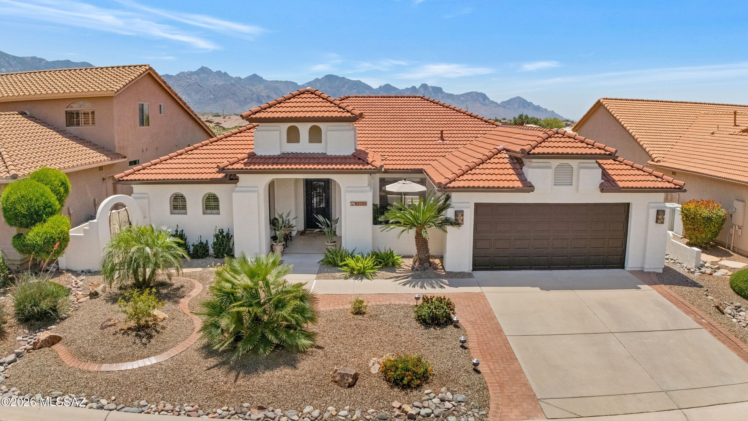 Updated Silverton with Mountain Views & Great Curb Appeal! Courtyard & custom entry door welcome you in. Living room & dining area offer ideal space for entertaining. Kitchen features granite counters, Monogram stainless appliances, gas range with vent hood, & 42'' cherry cabinets with soft-close. Kitchen nook opens to family room with gas fireplace & slider to patio. Owner's Suite has ensuite bath with dual vanity with quartz counter, custom cabinet, walk-in shower, & 2 closets. Den/Office. Guest bedroom with closet. Nearby bath has walk-in shower. Laundry room with W/D & cabinets.  Water purification system. Extended 2-car garage with newer HVAC, cabinets. Outdoor living with covered patio, 4 electric rolling shades, extended patio, beehive fireplace, & gated yard with mountain views!