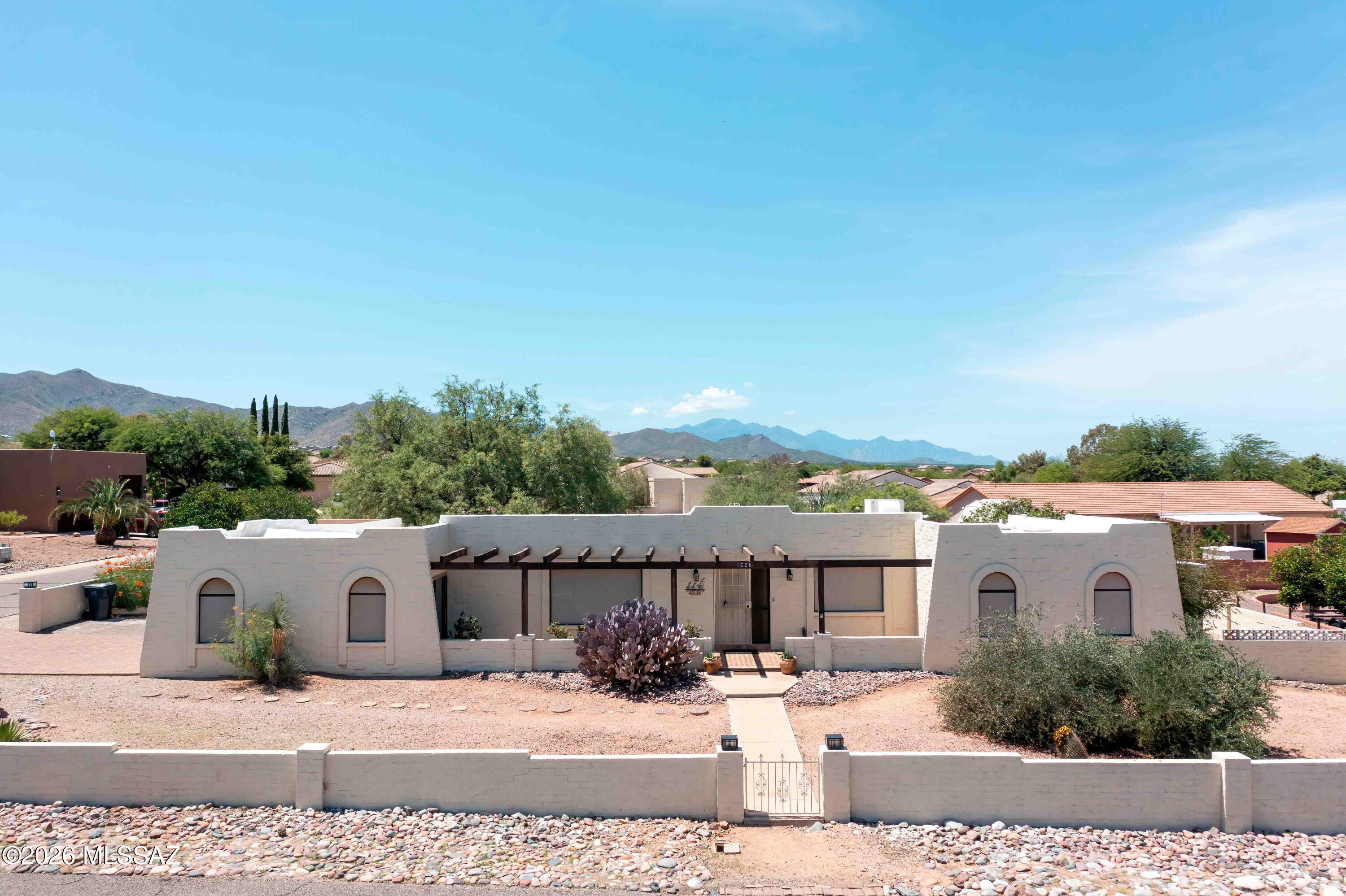 With only one neighboring property & rare .65-acre lot, this 3-bedroom, 2.5-bath home offers a unique combination of privacy & space that's hard to find in this subdivision. Located in the award-winning Vail School District, the home features fresh interior paint, new carpet in bedrooms & beautiful Saltillo tile throughout. The flexible floor plan includes a den or optional 4th bedroom plus an Arizona room, providing additional year-round living space. Recent updates include a newer water heater, water softener, & a recently recoated roof. The spacious backyard features mature fruit trees & a sparkling pool for enjoying Arizona's sunny days. The home also offers a 2-car garage w/ storage & separate golf cart garage. Enjoy preserved views and all this special property has to offer!